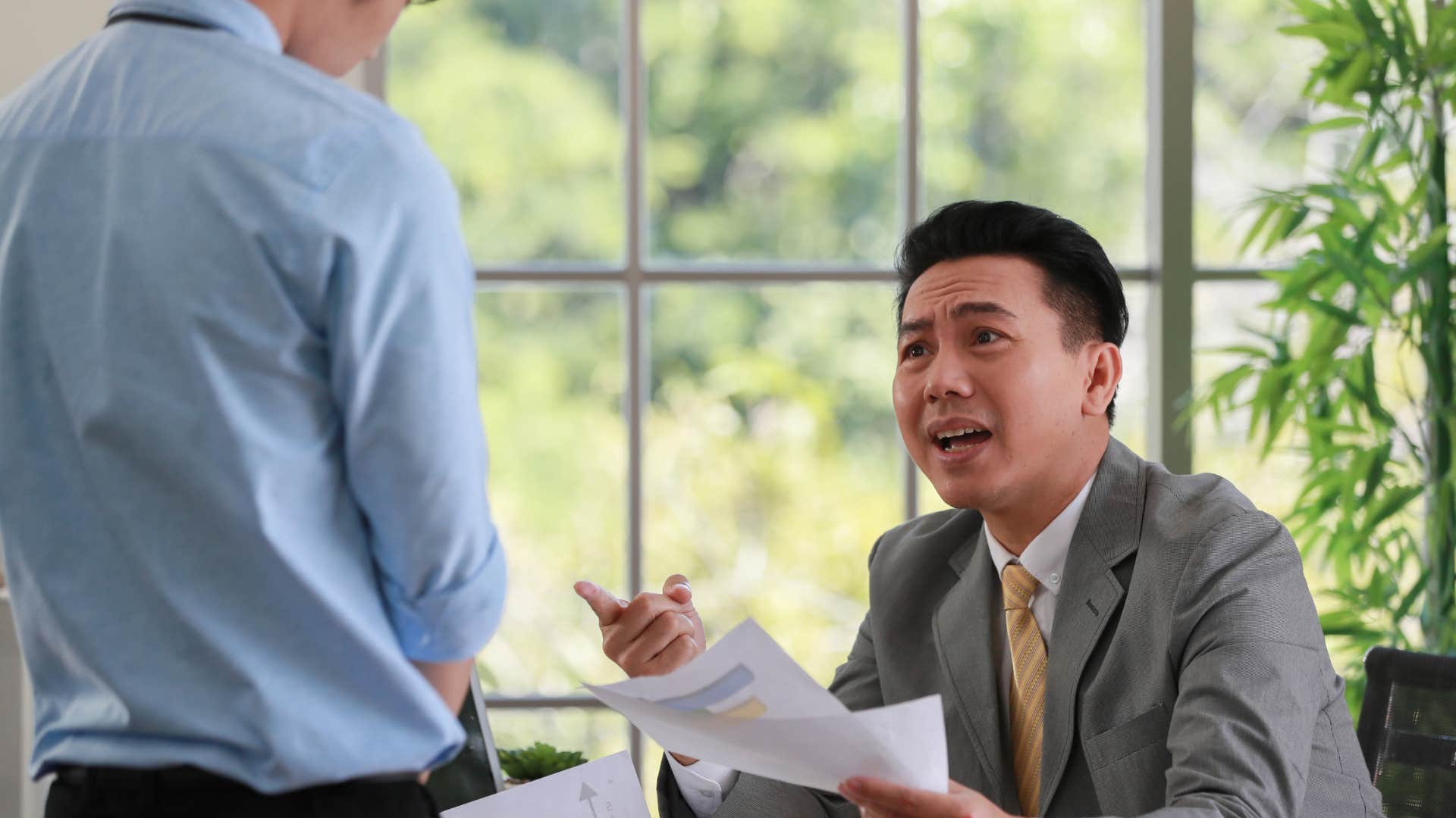 frustrated lazy worker telling manager he's swamped today