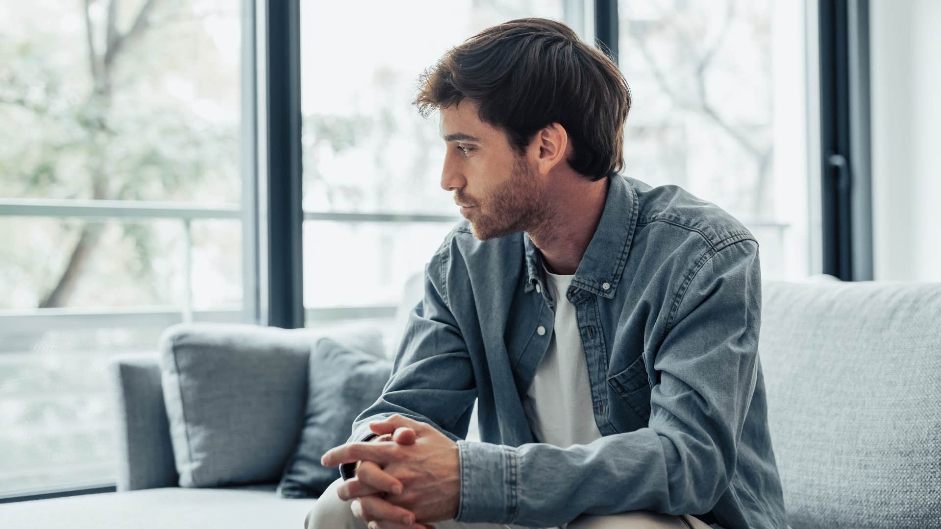 man in denim jacket looking off to the side as he thinks you're better off without me
