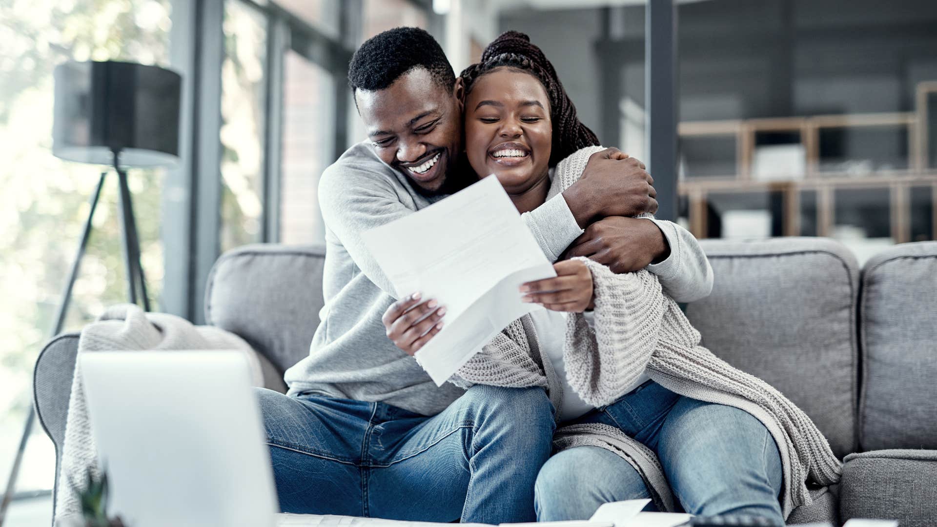 couple deciding to work together as they smile and hug one another