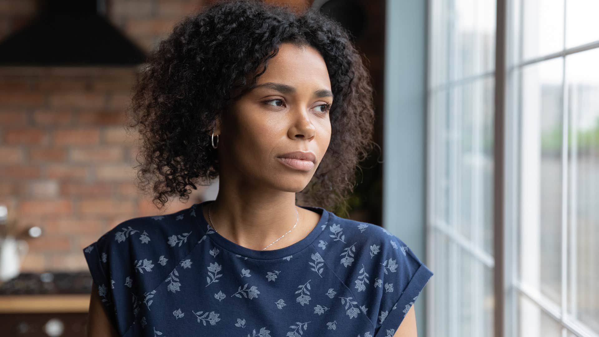 woman saying I'm fine while looking out the window sadly