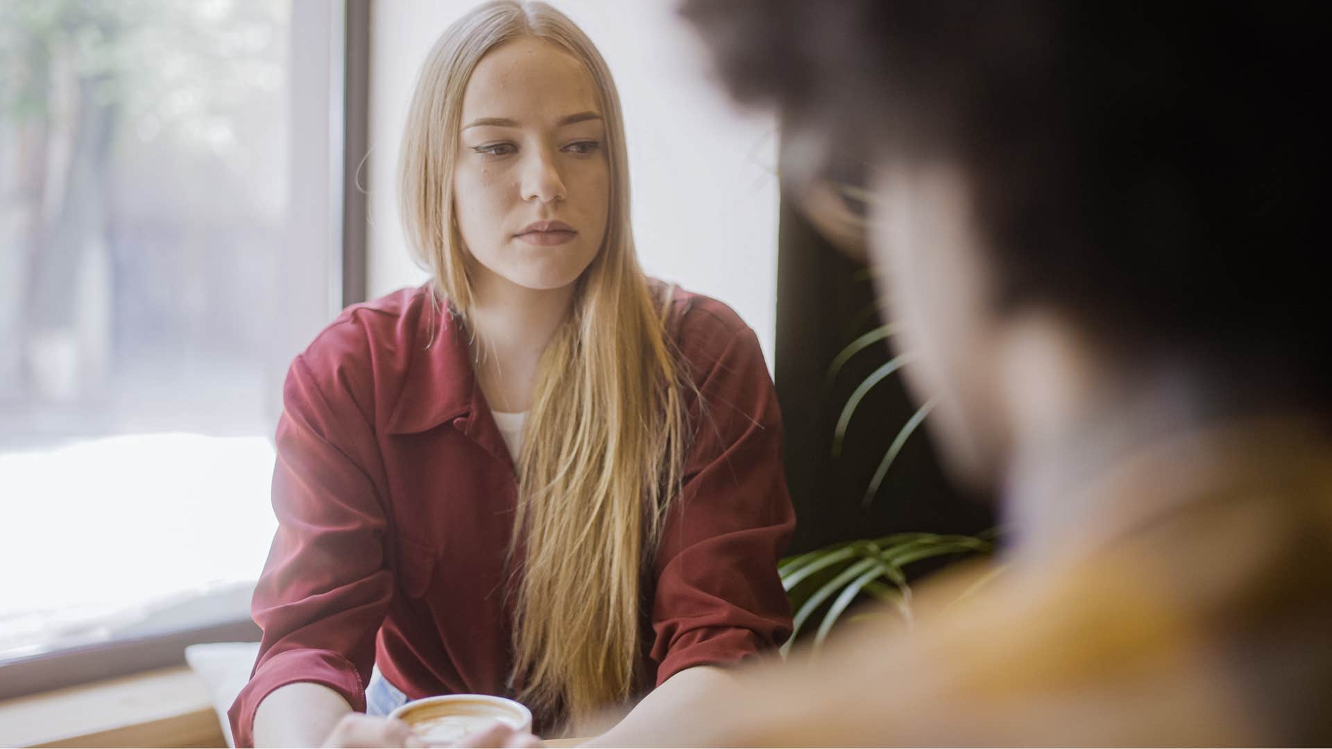 miserable woman saying it's just one of those days to her friend