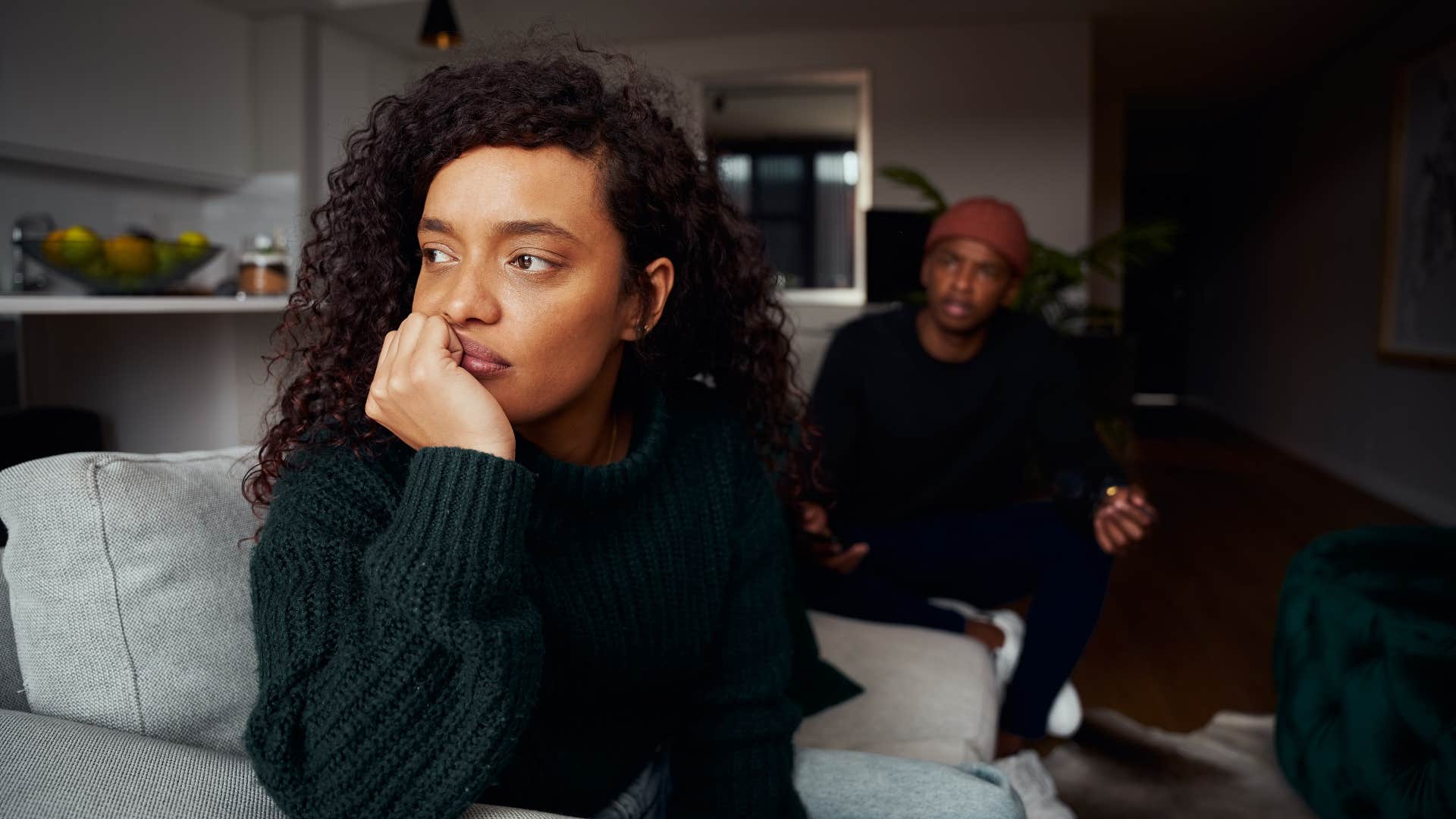 woman in green sweater ignoring man while thinking i just need some space