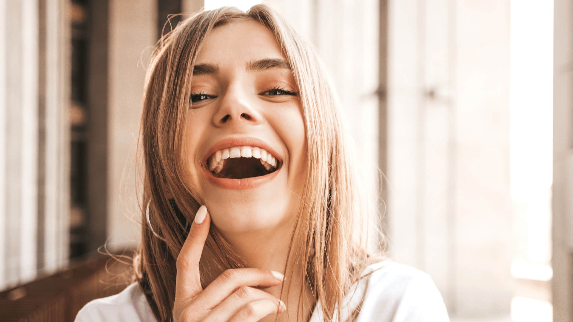 woman smiles more than her ex expects to make them regret losing her