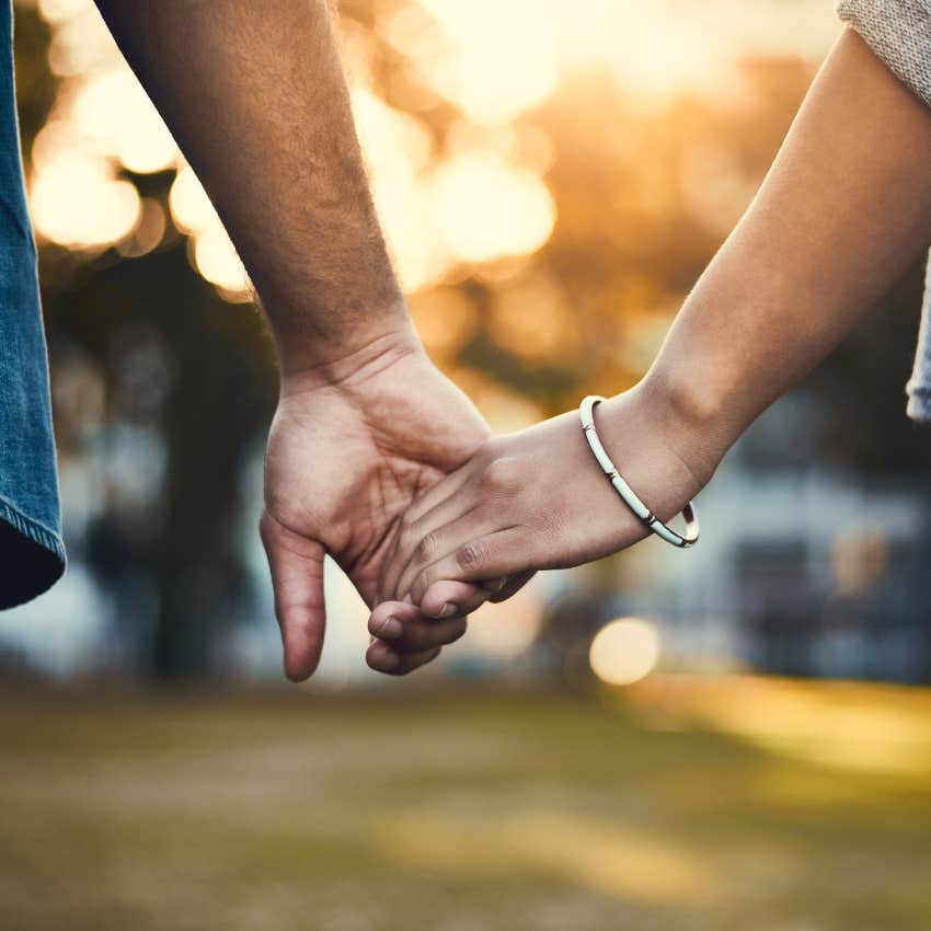 confident couple with nothing to prove holding hands