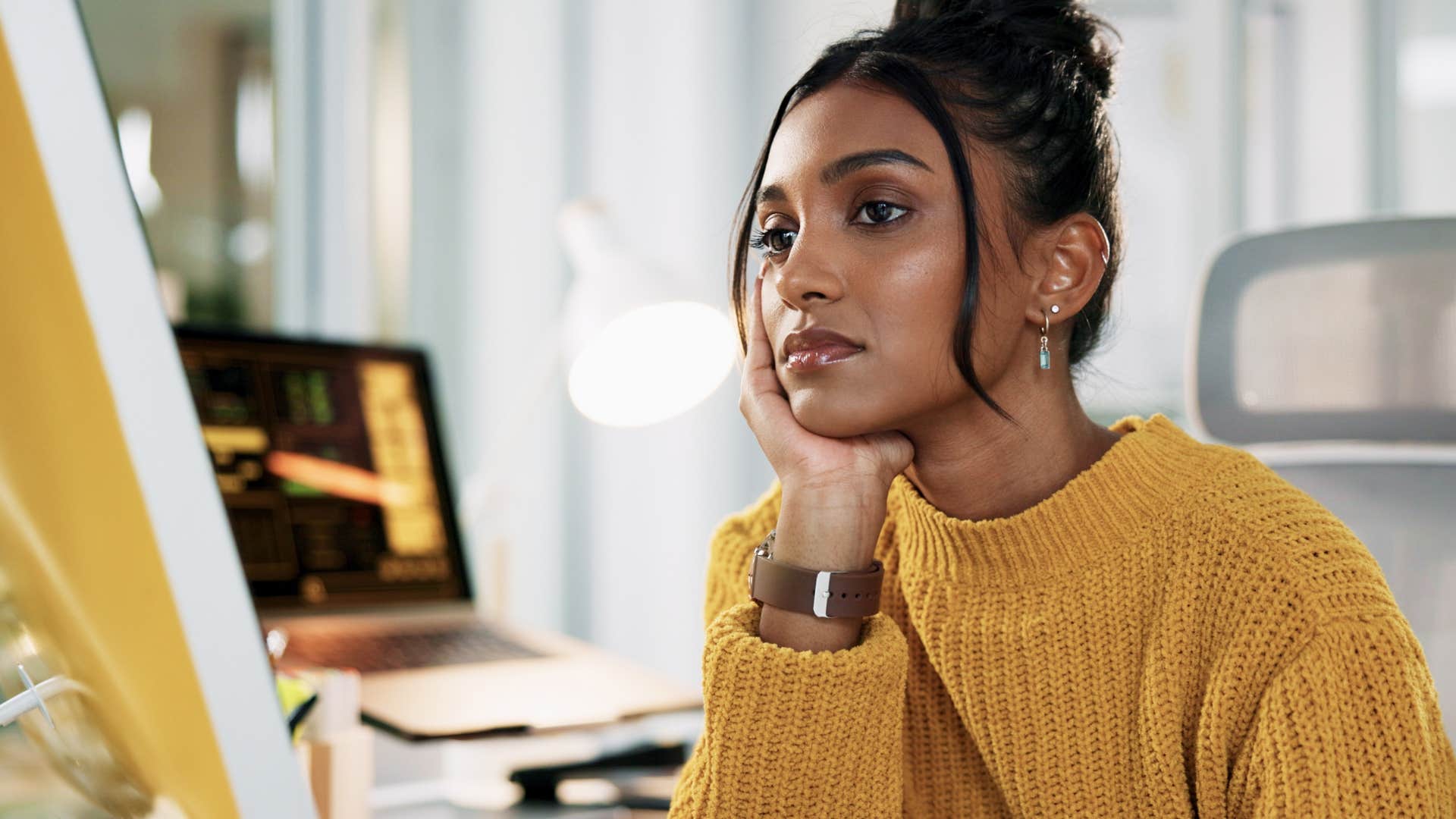 Woman who's always comparing themselves to others sitting alone.