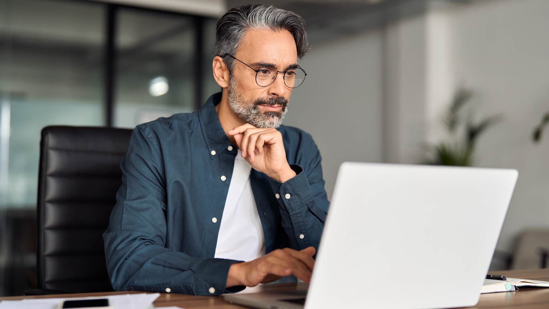 Man who seeks learning opportunities working at his desk.