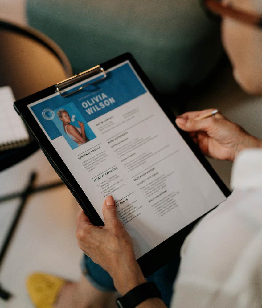 recruiter holding job candidate's resume
