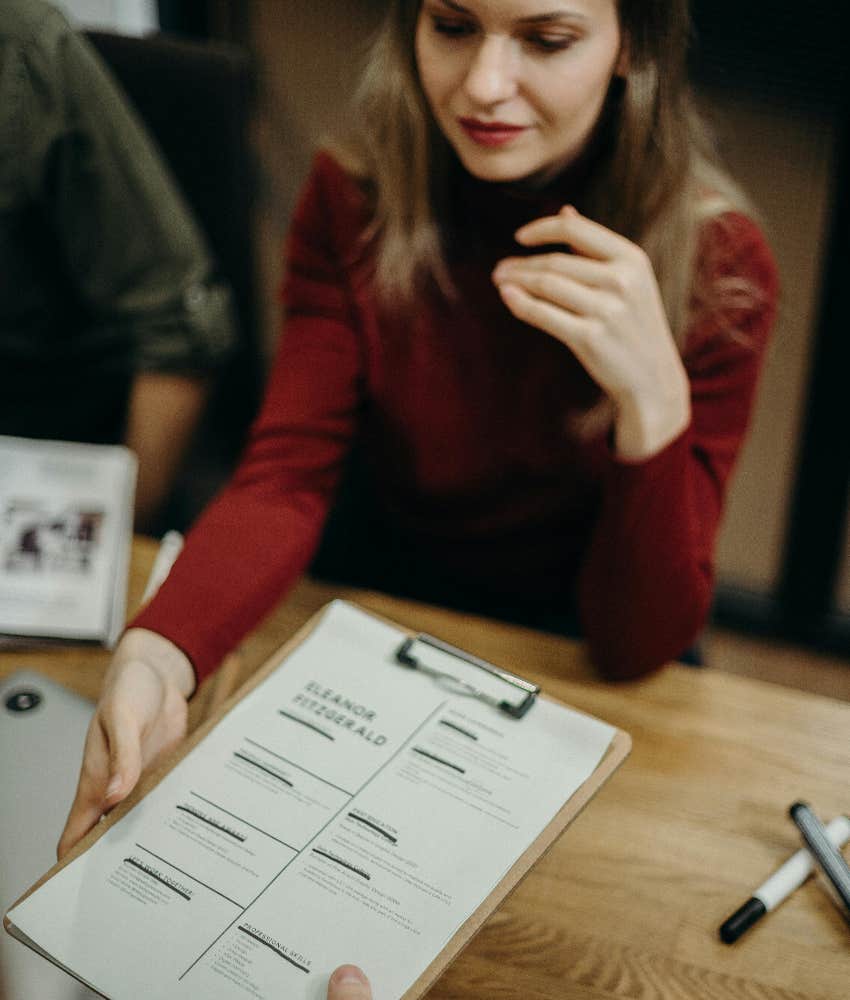 woman handing over her resume