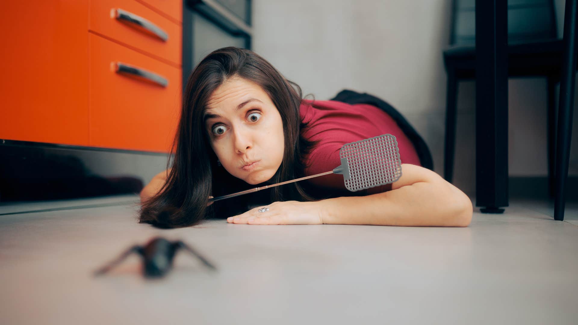 woman trying to hunt down a bug in her home