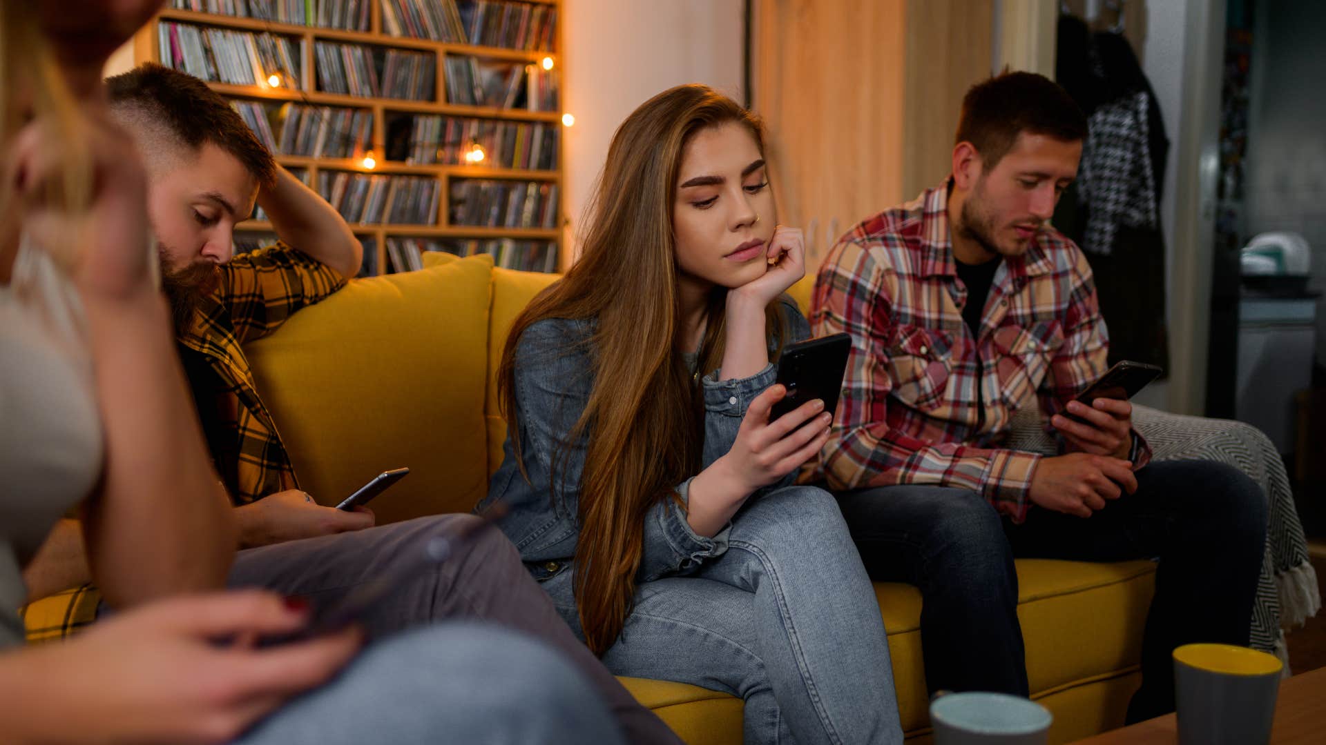 group of friends hanging out but glued to their phones