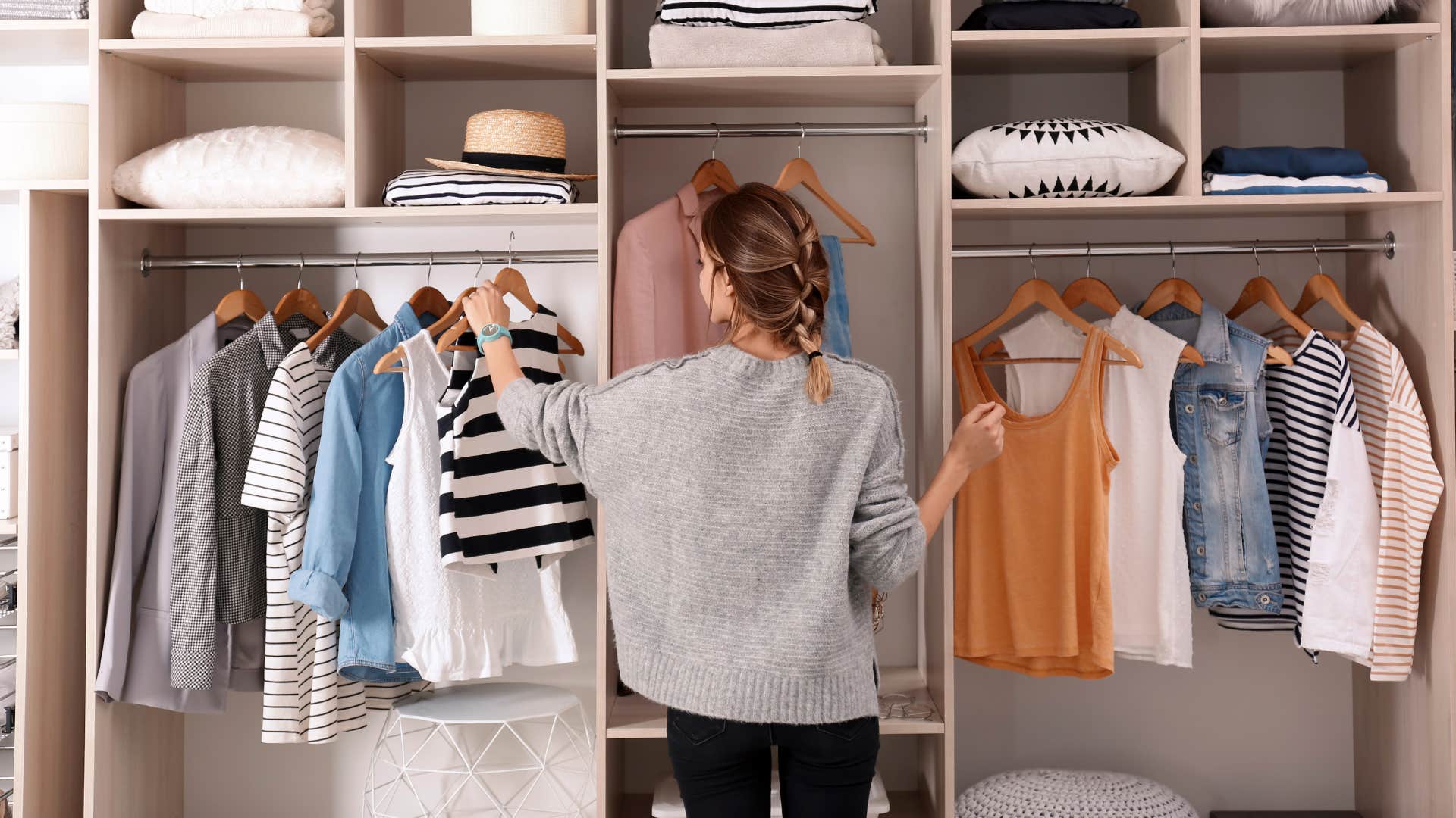 woman in her closet with trendy clothes and decor