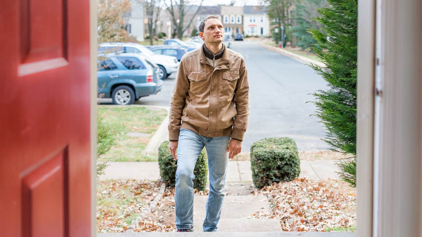 Red Flags You Can Spot In A House Before You Even Sit Down man looking at house outside before entering front door
