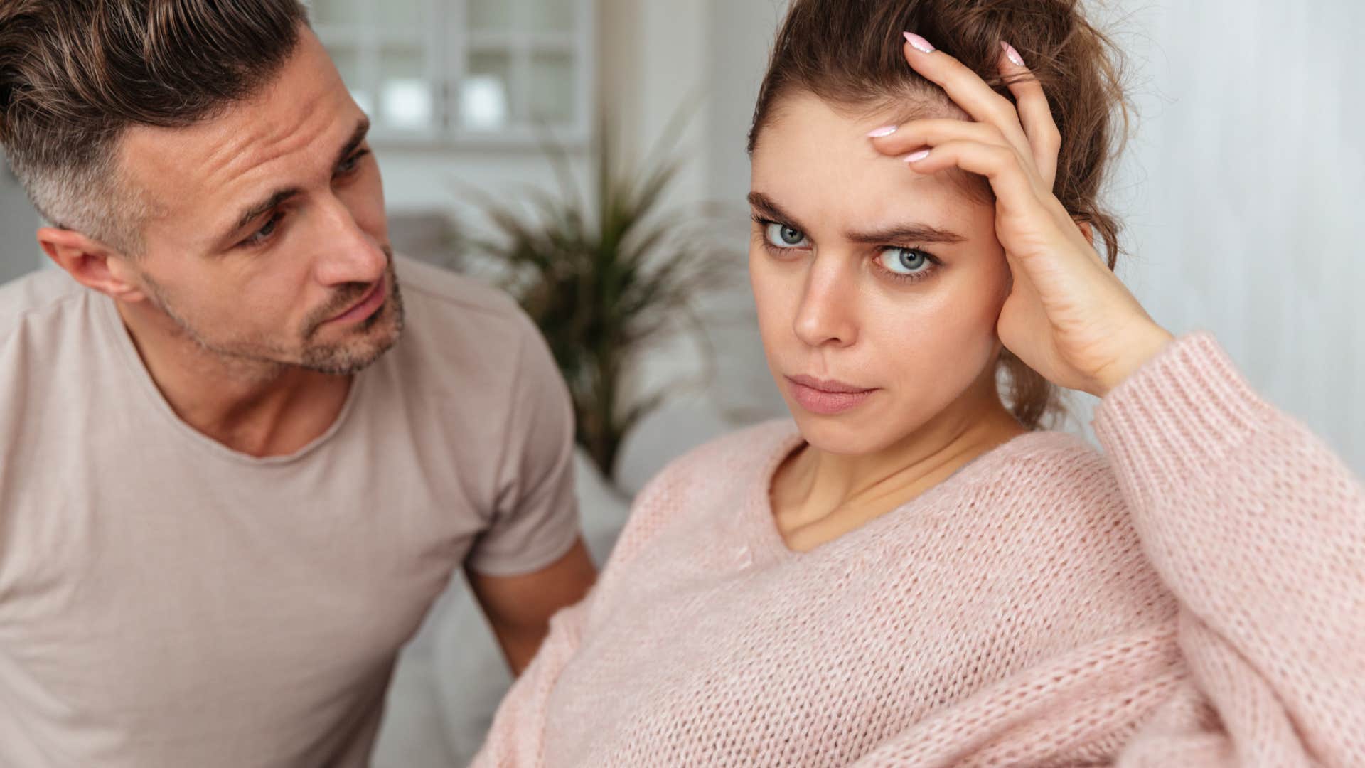 man talking to very defensive woman
