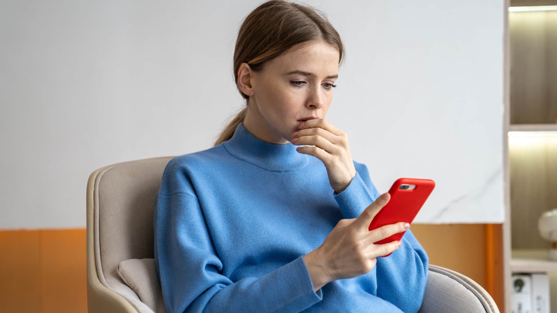 woman with a broken heart on her phone as a distraction