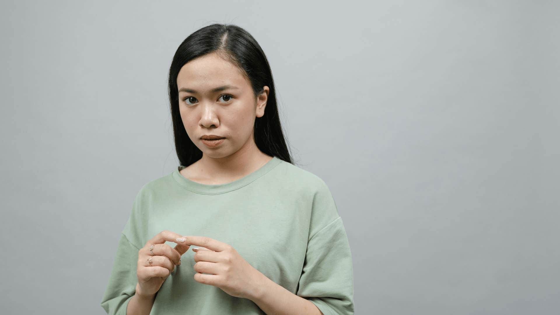 serious young woman believing there is something wrong with her