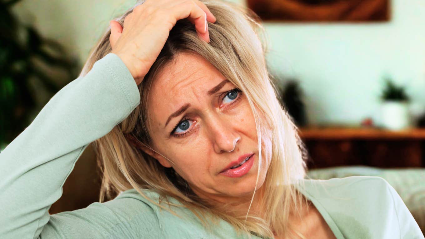 Signs You've Outgrown The Person You Once Loved, According To Psychology Woman realizing she has outgrown the person she once loved.