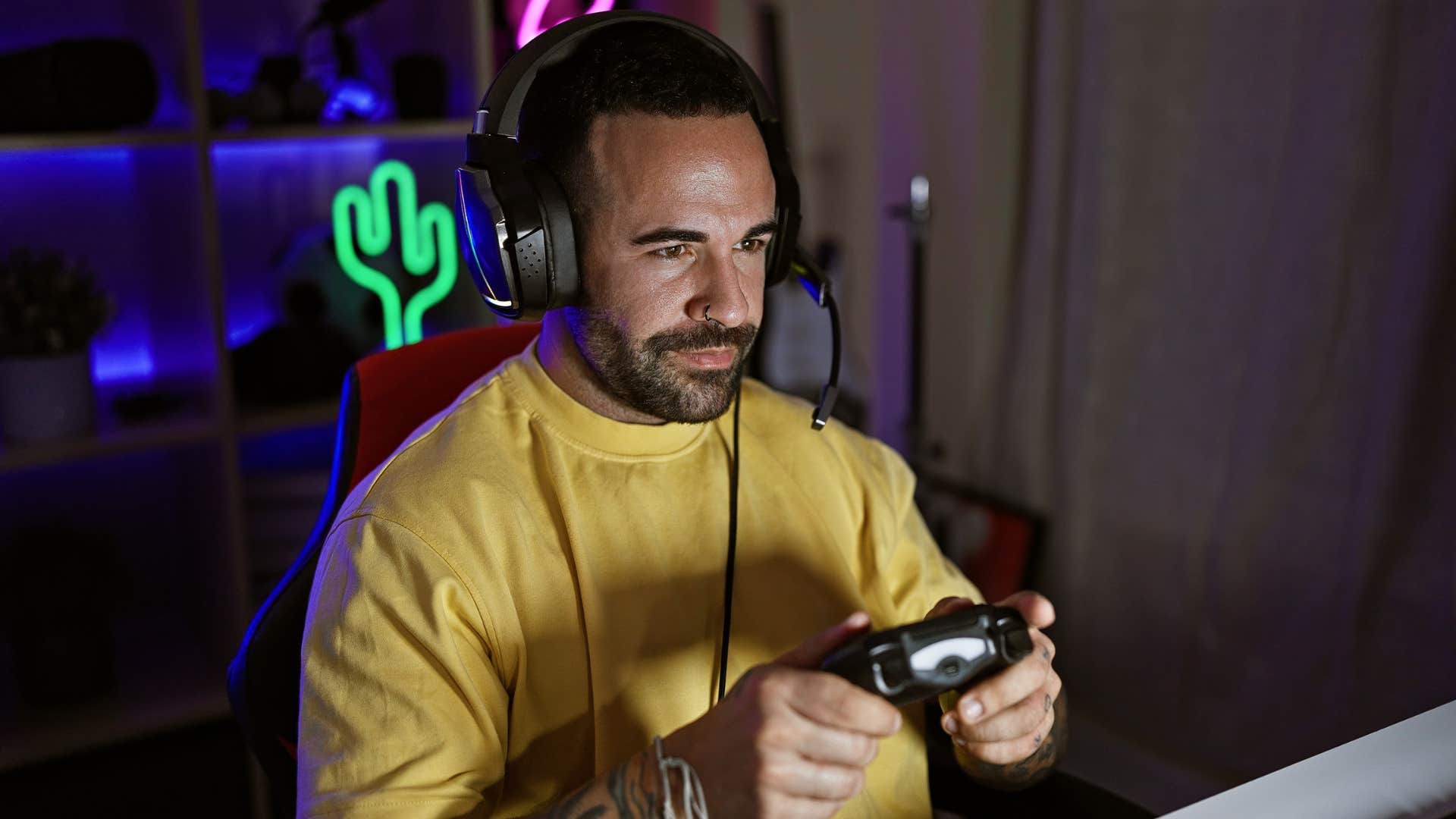 man playing video games ignoring his responsibilities