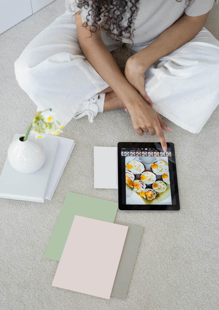 woman with diverse interests looking at tablet and papers
