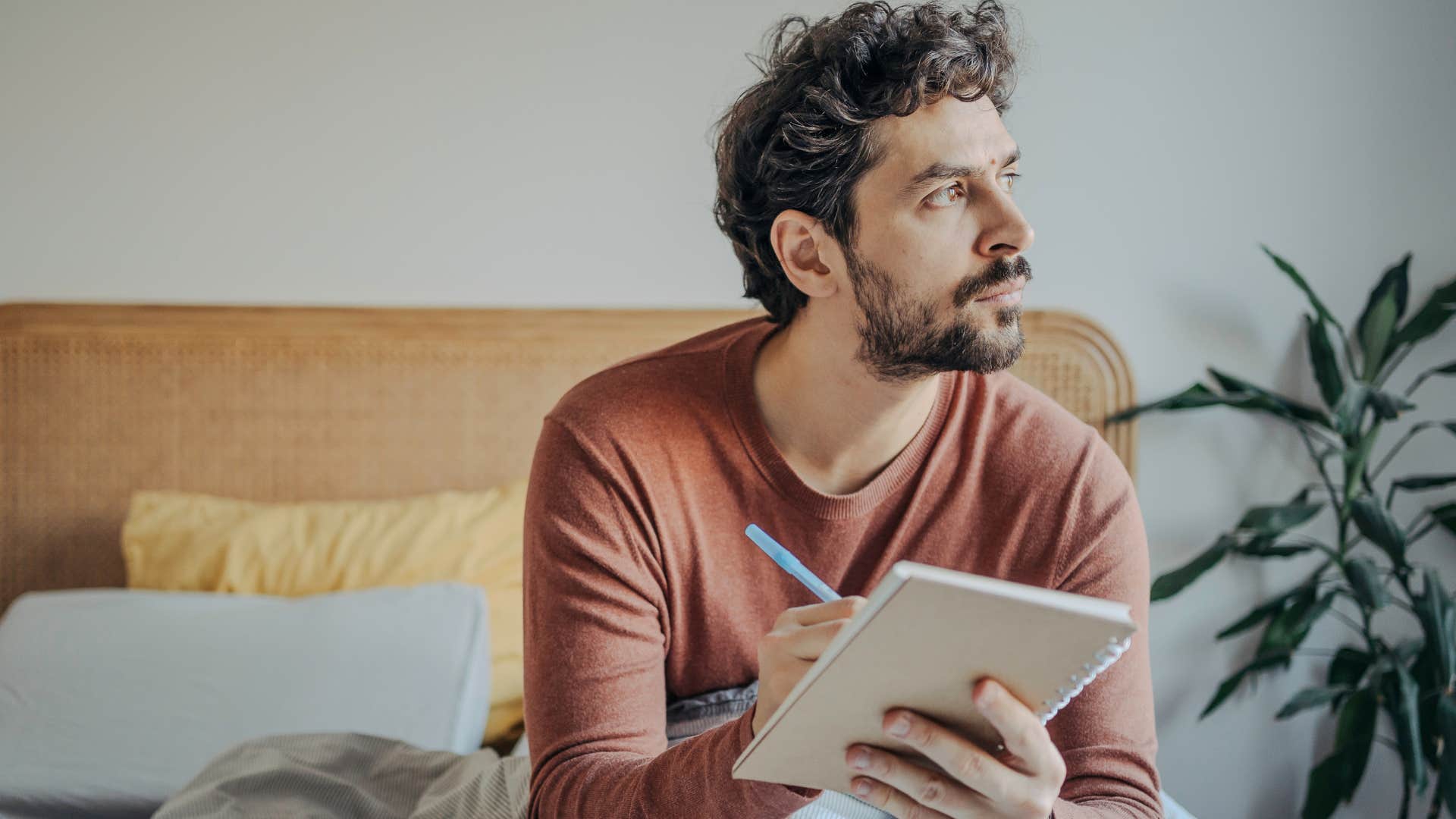 man who values his time and space journaling in bed