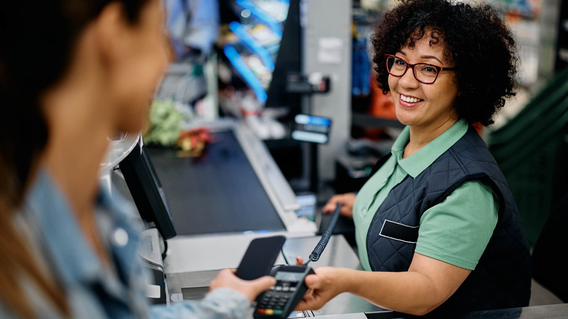 woman using coupons to pay at the grocery store