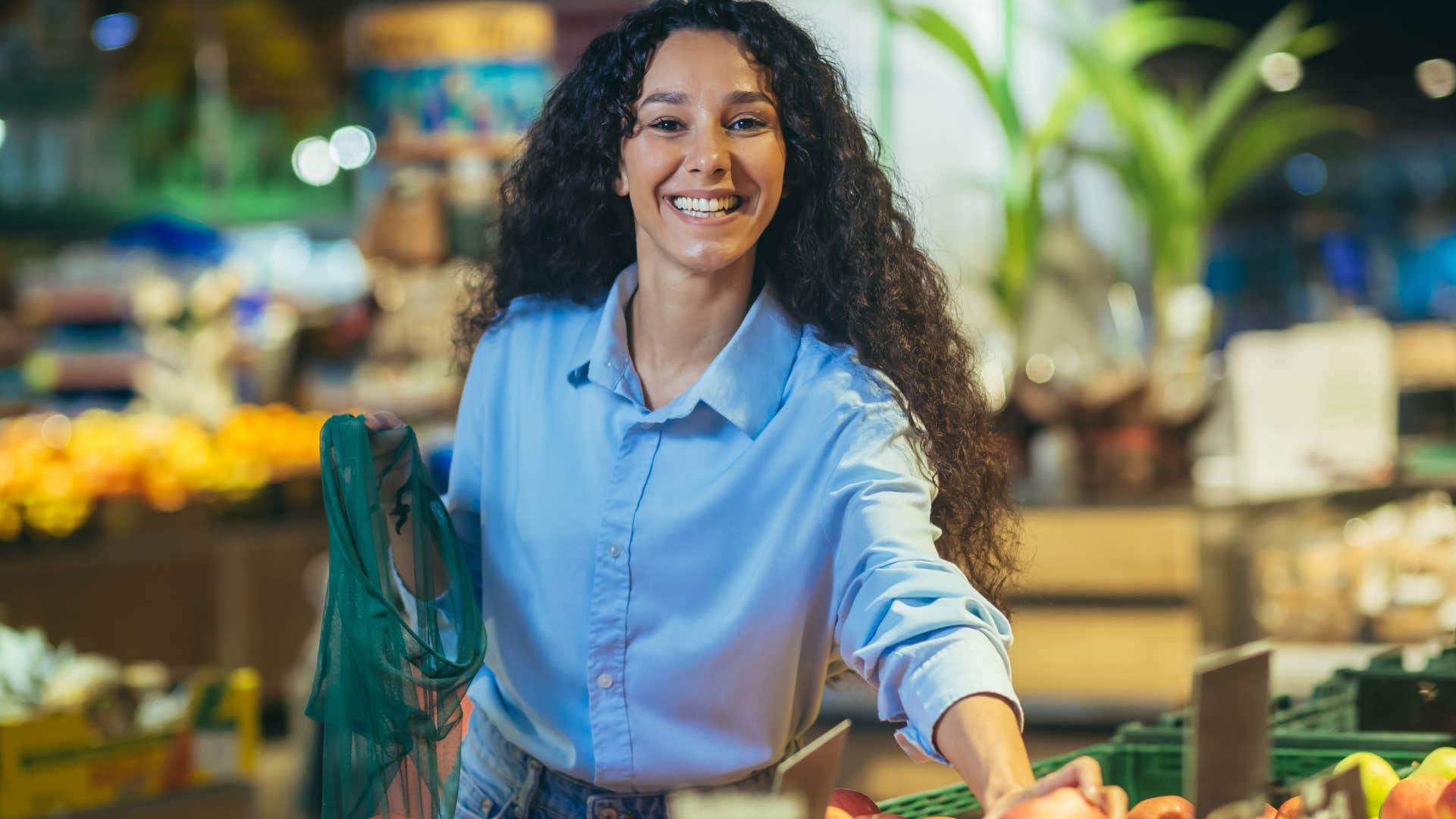woman who doesn't pay extra for convenience smiling in the grocery store