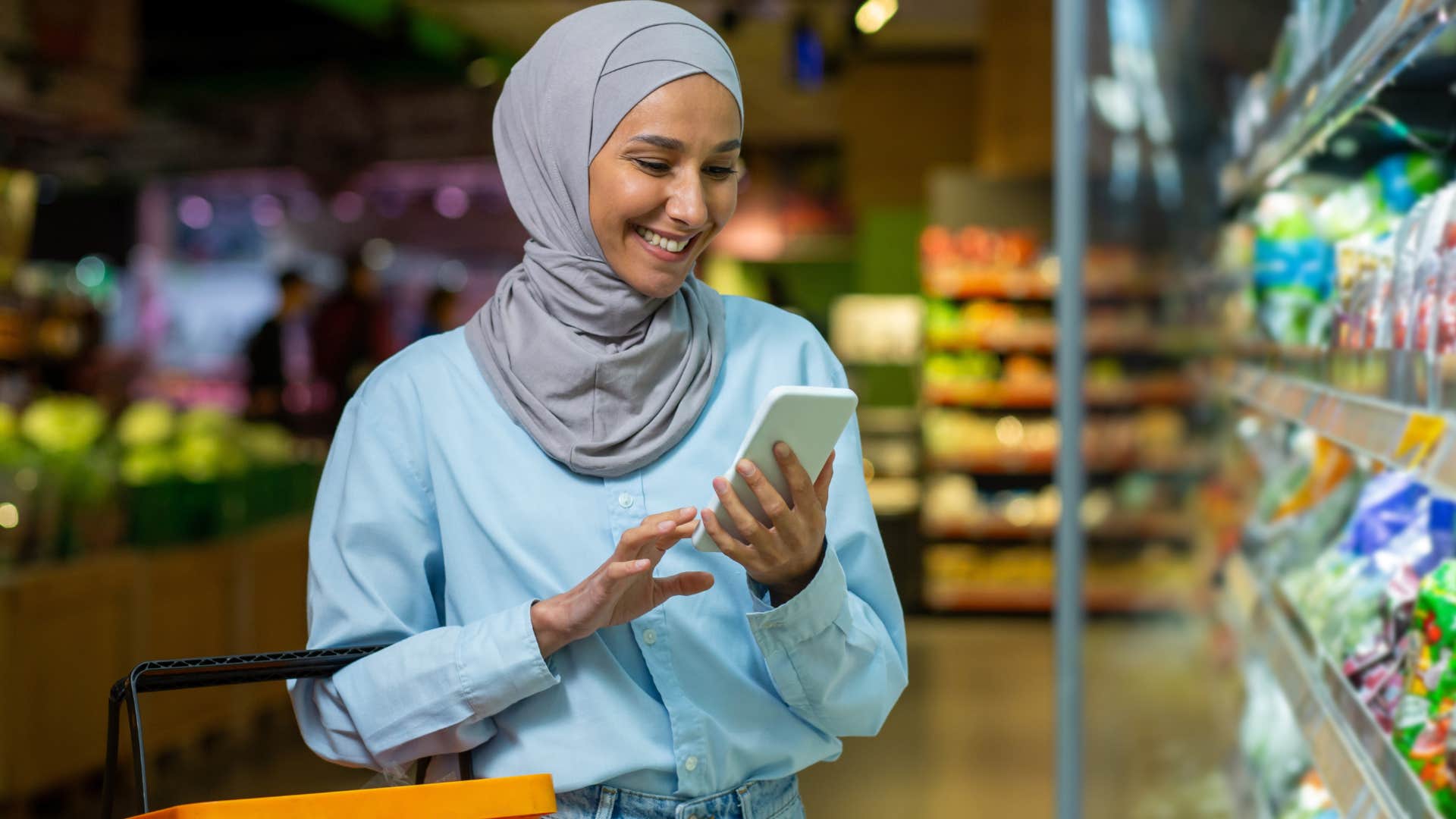 woman who plans meals around her pantry smiling in the grocery store