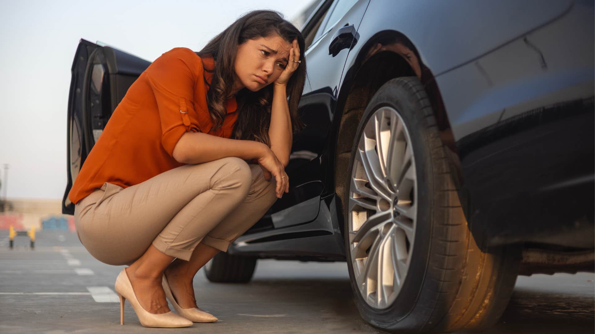 a woman wishes she had a spare tire after it went flat while she was driving
