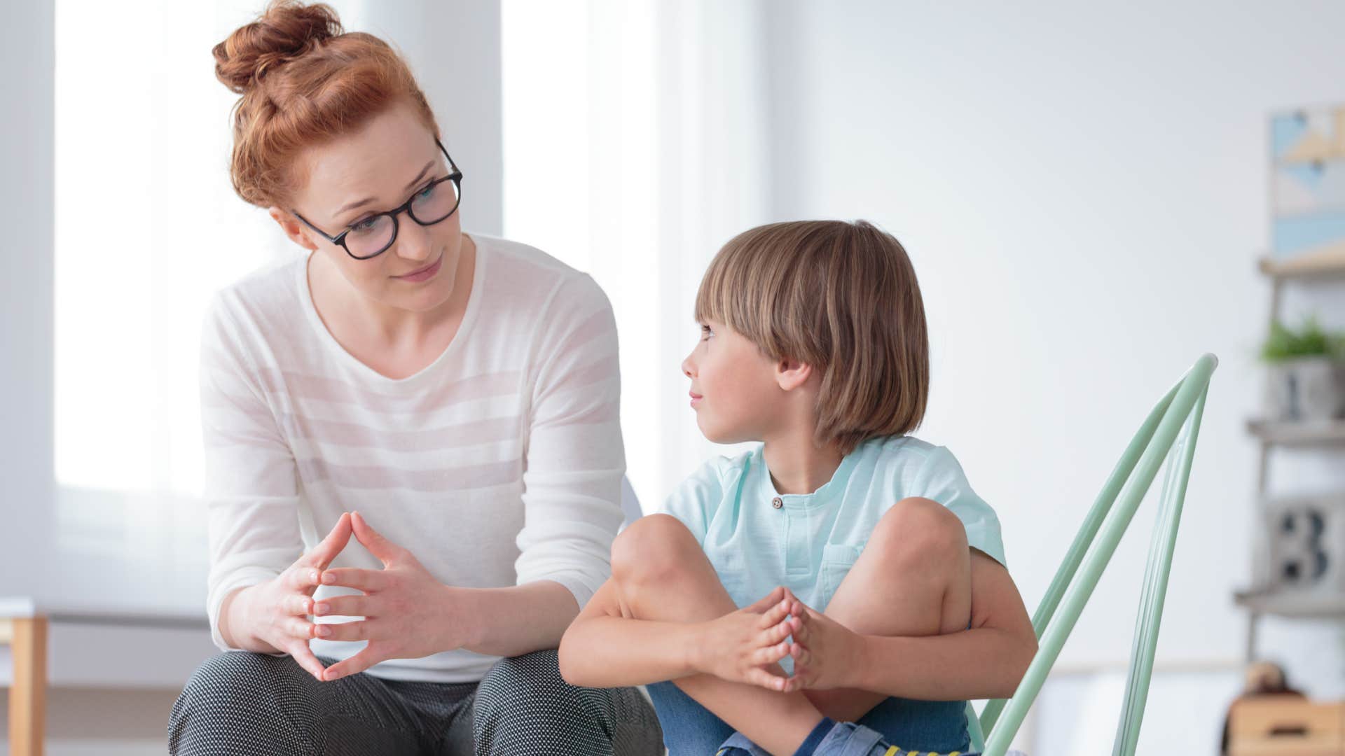 calm mom recognizing resistance from her son talking to him