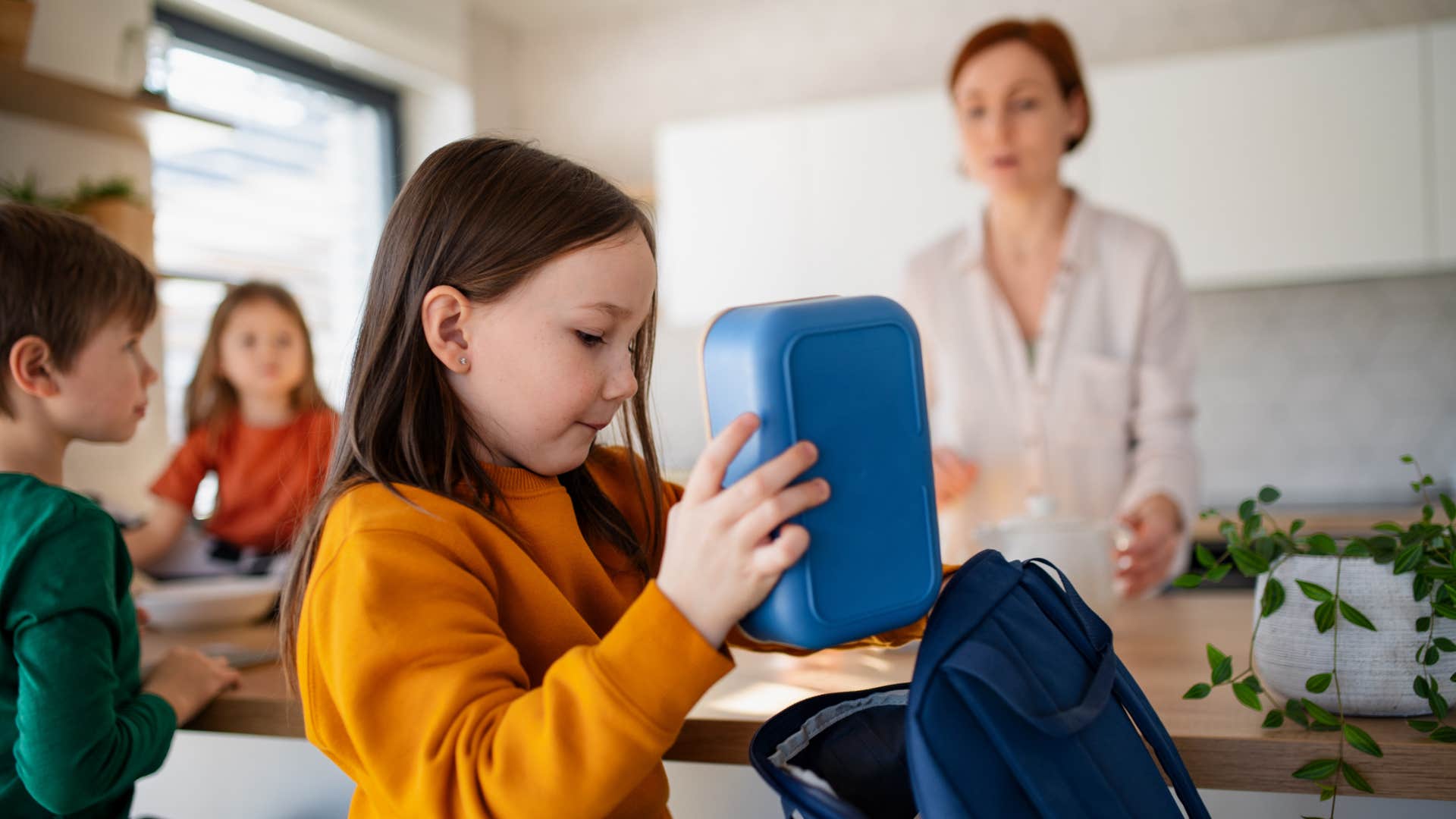 young girl packing lunch as part of routine and structure