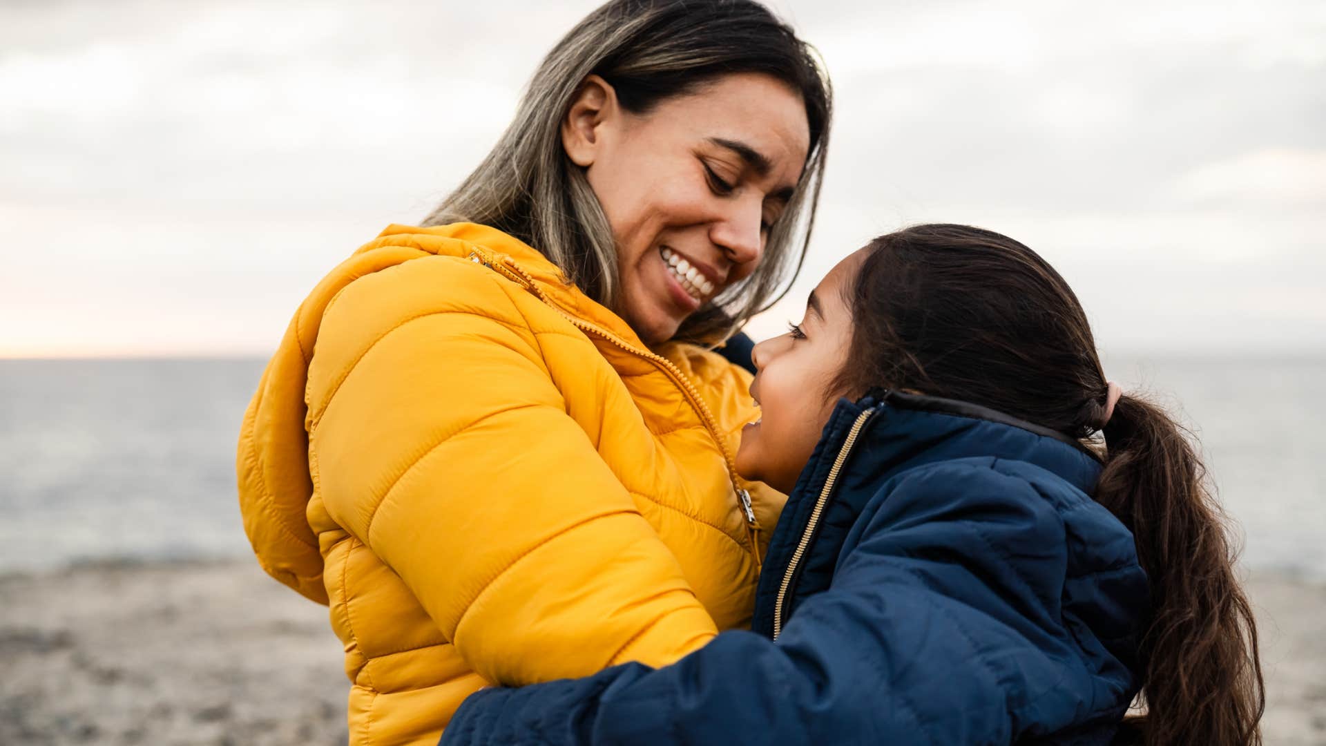 mom being supportive of daughter hugging her on a boat