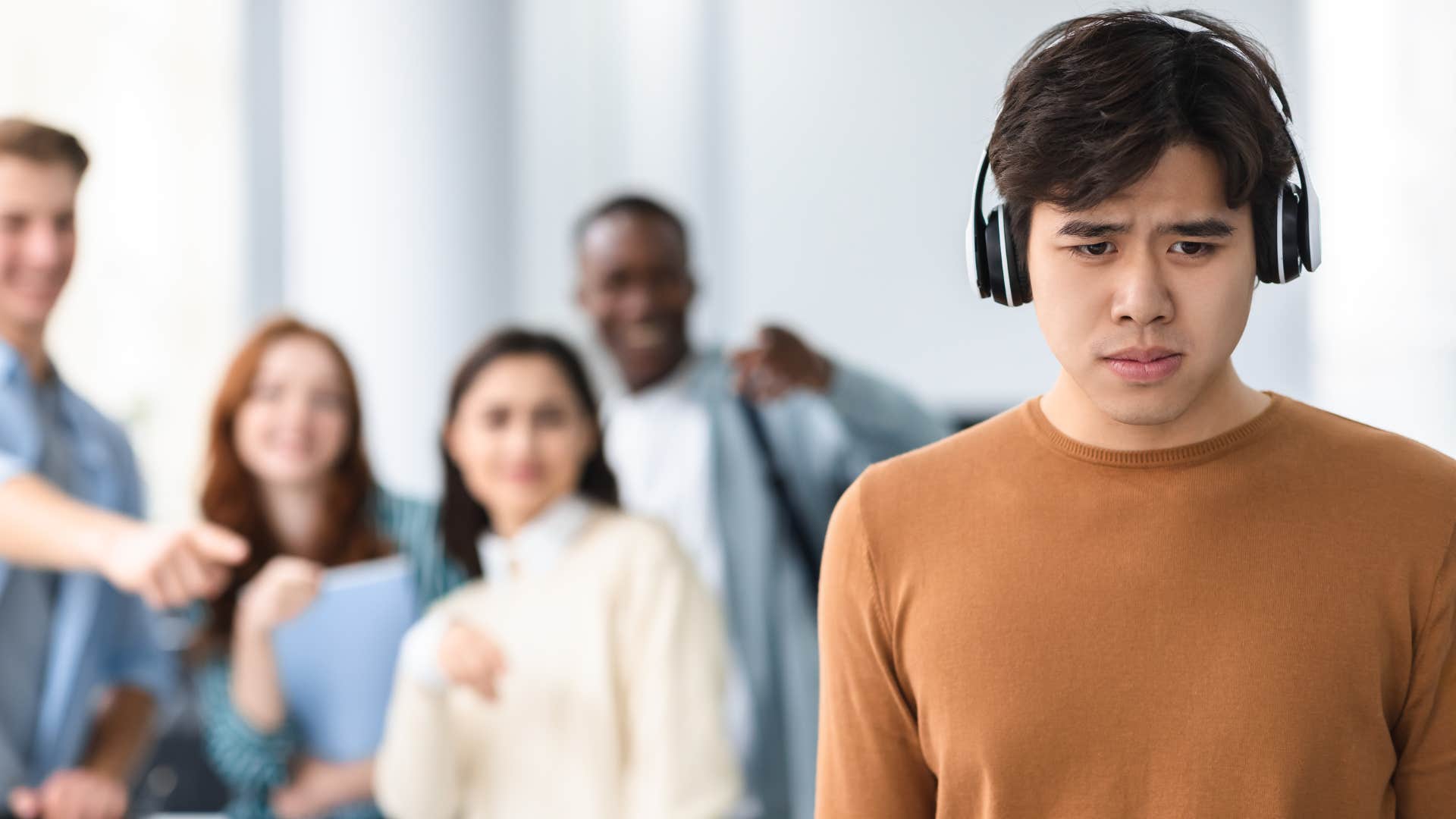 intelligent young man refusing to follow the crowd to be accepted