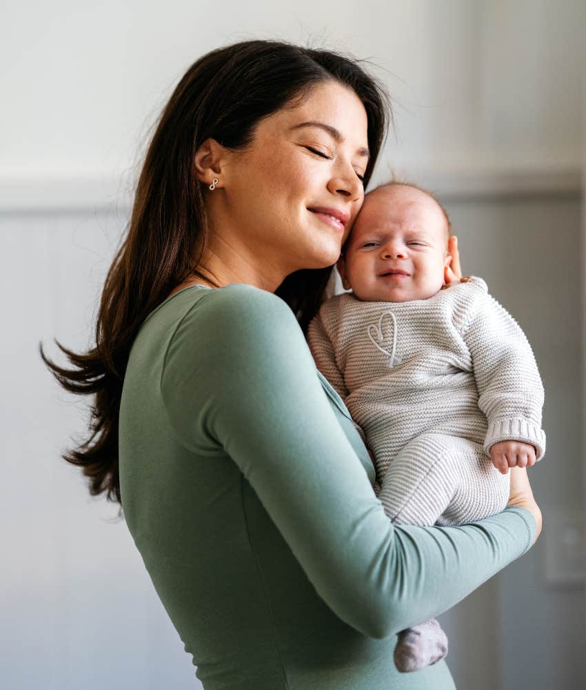 Mom hugs baby.