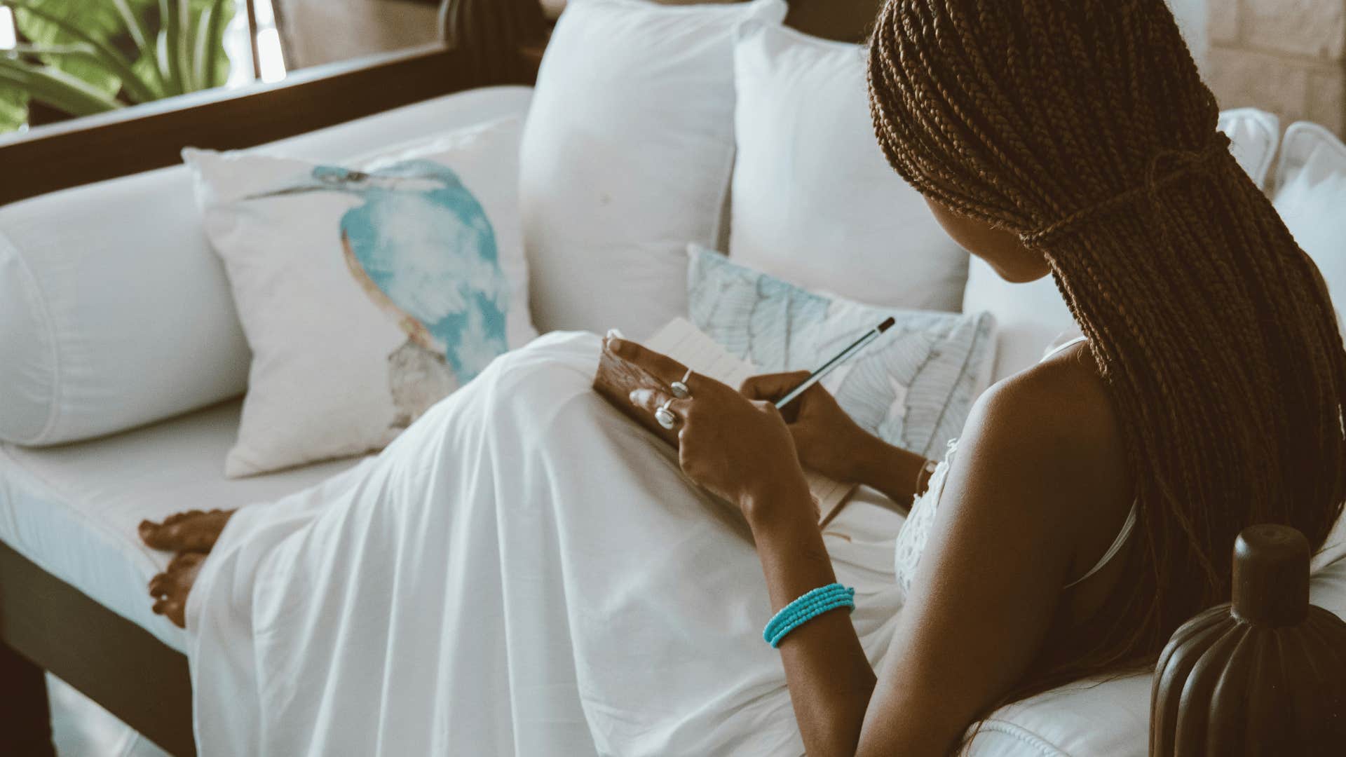 woman writing letter to herself to stop heart from breaking