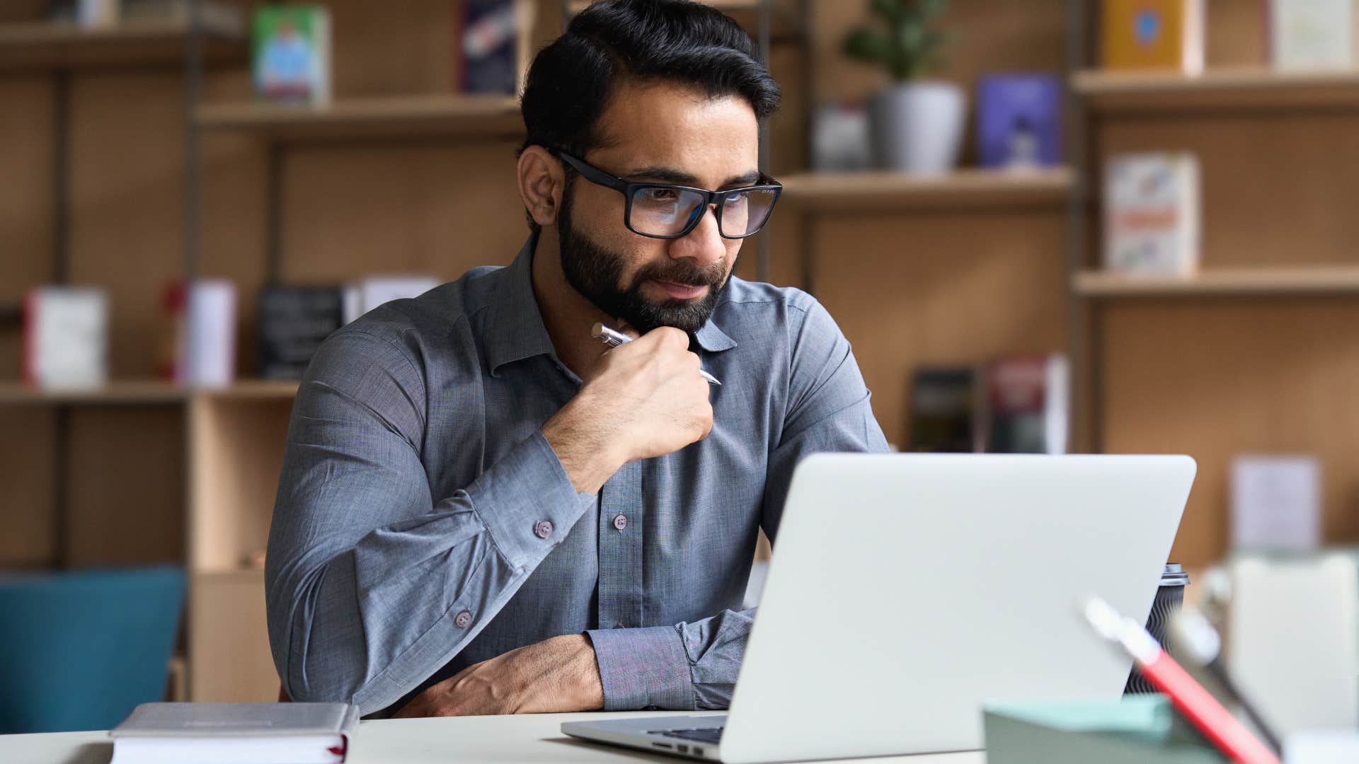 serious man passionately looking at work laptop