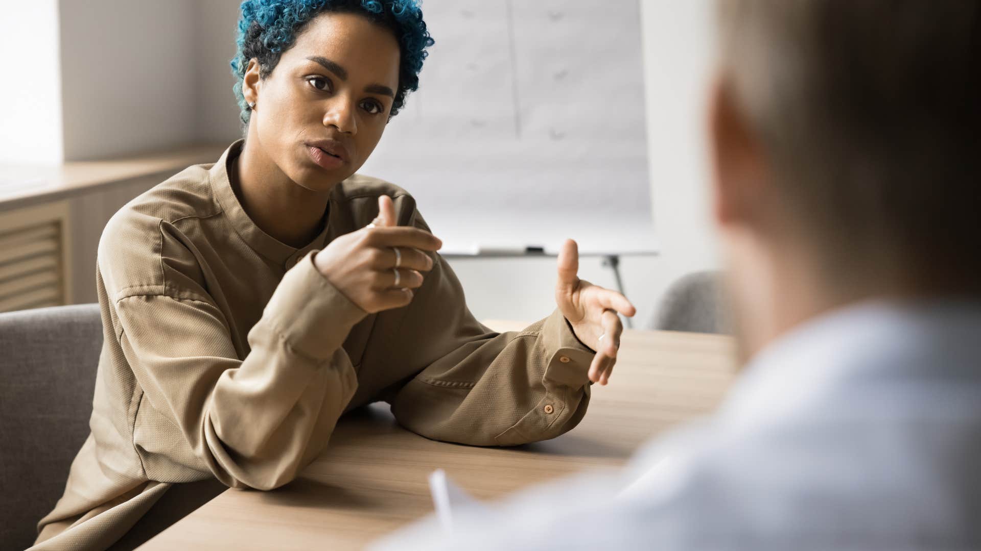 employee talking to colleague in meeting
