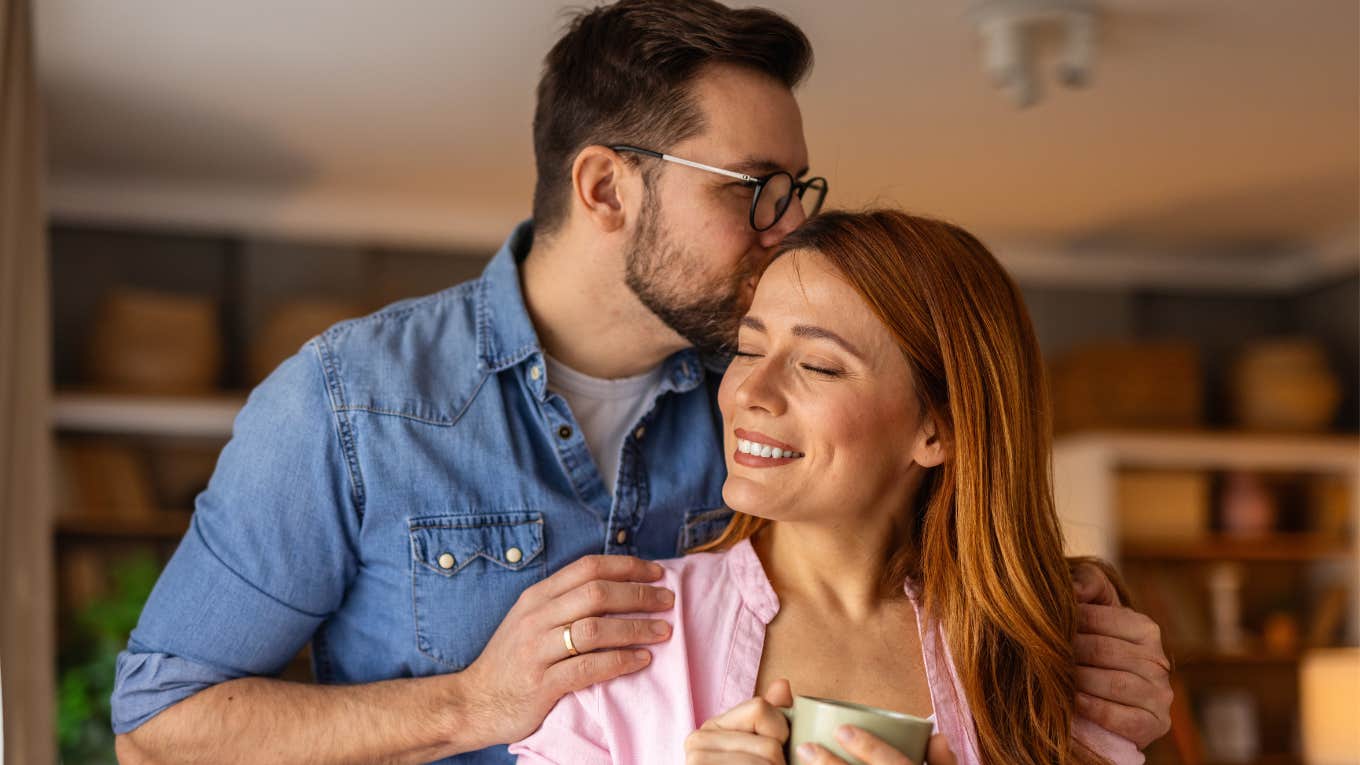 man lovingly kissing the head of the woman he loves