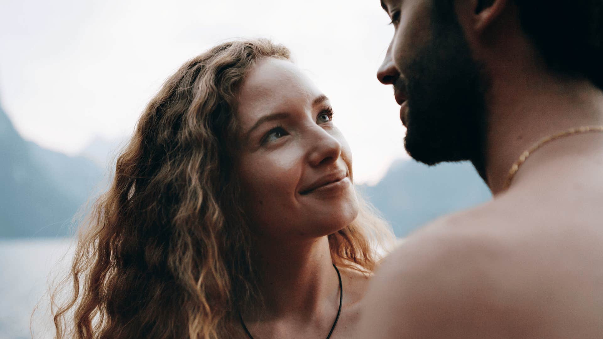 man suspects woman is lying to him because she suddenly turns on the charm