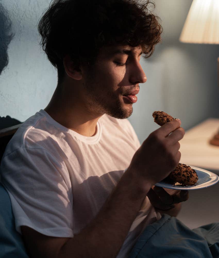 Man eats food.