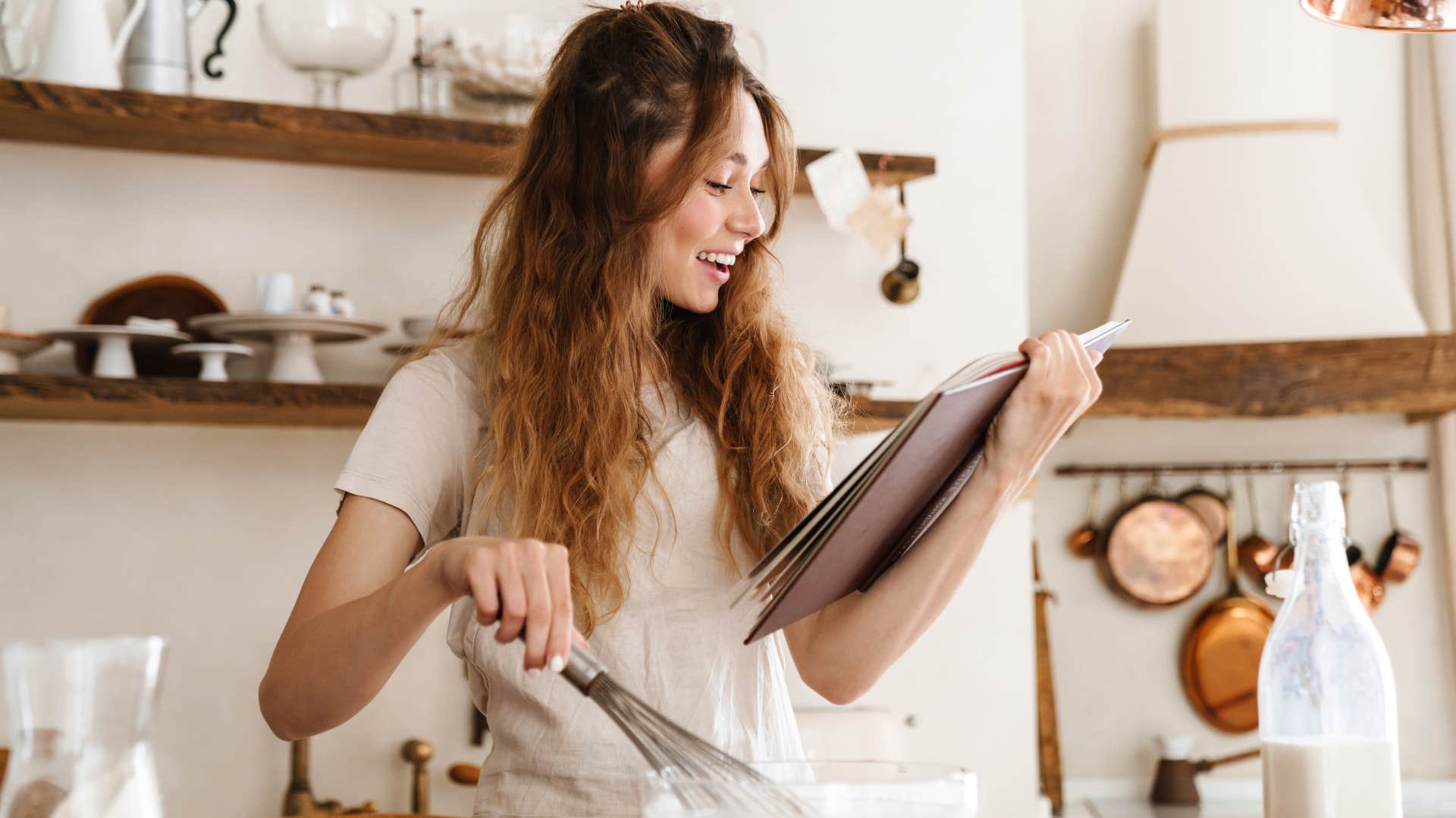 a gen z woman uses her grandmothers recipe book to bake something