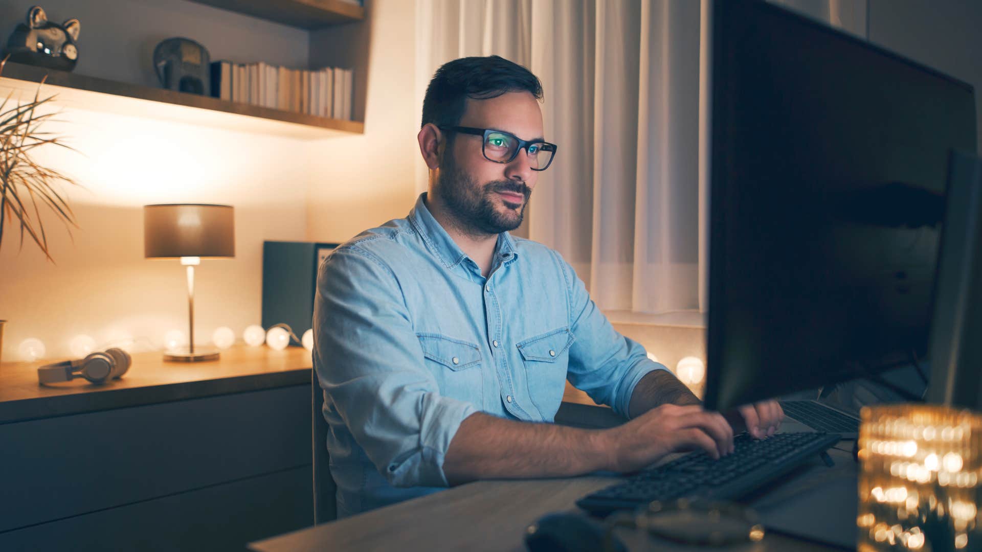 man working at a desk in low lighting