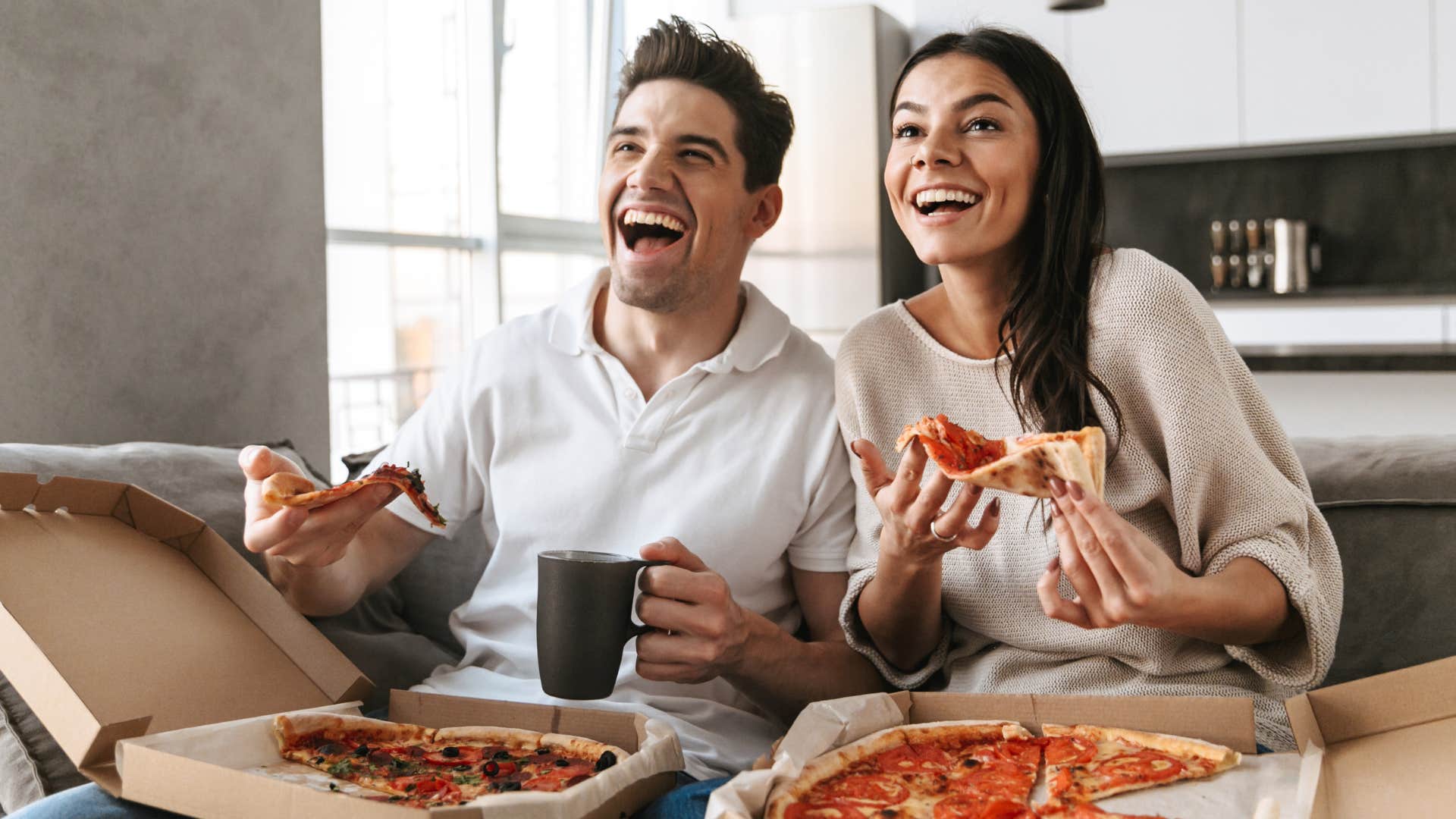 Gen Z couple with no formal dining room table eating on their couch