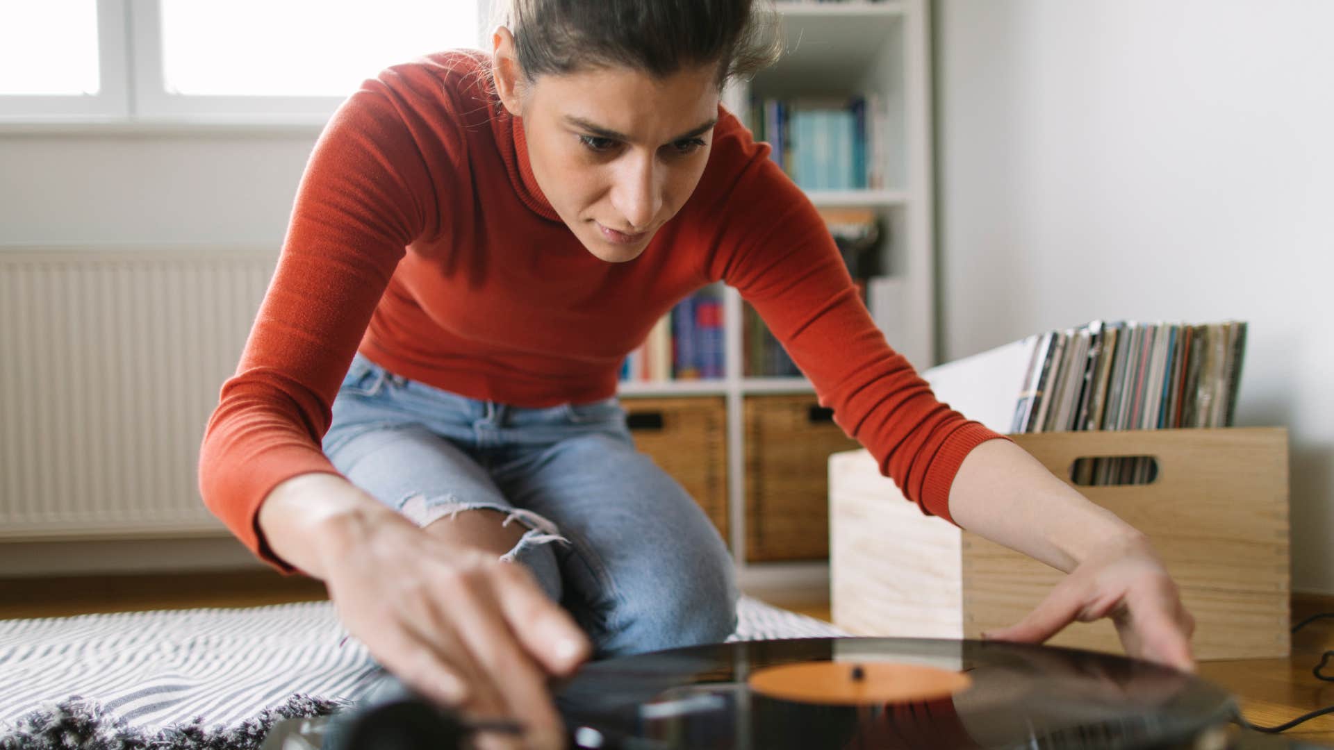 gen z woman using record player in her room