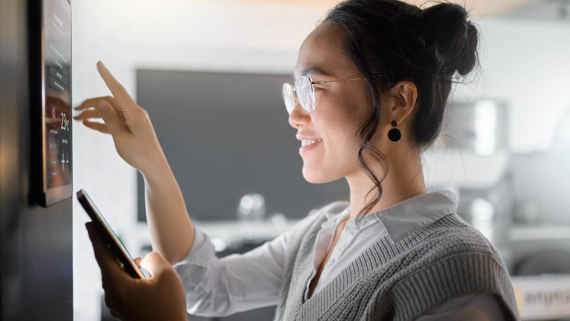 gen z woman using the smart devices in her home