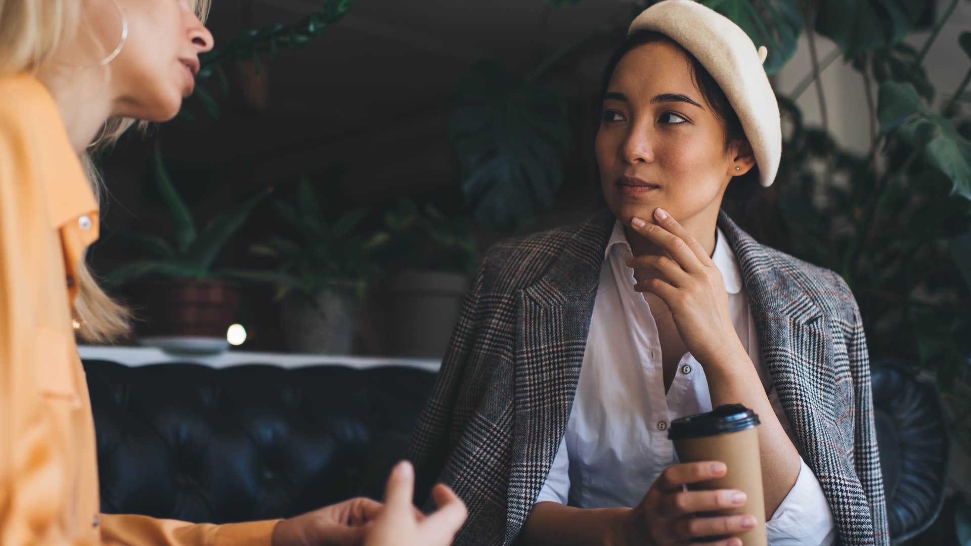 woman is desperate for attention looking at her friend in a coffee shop.