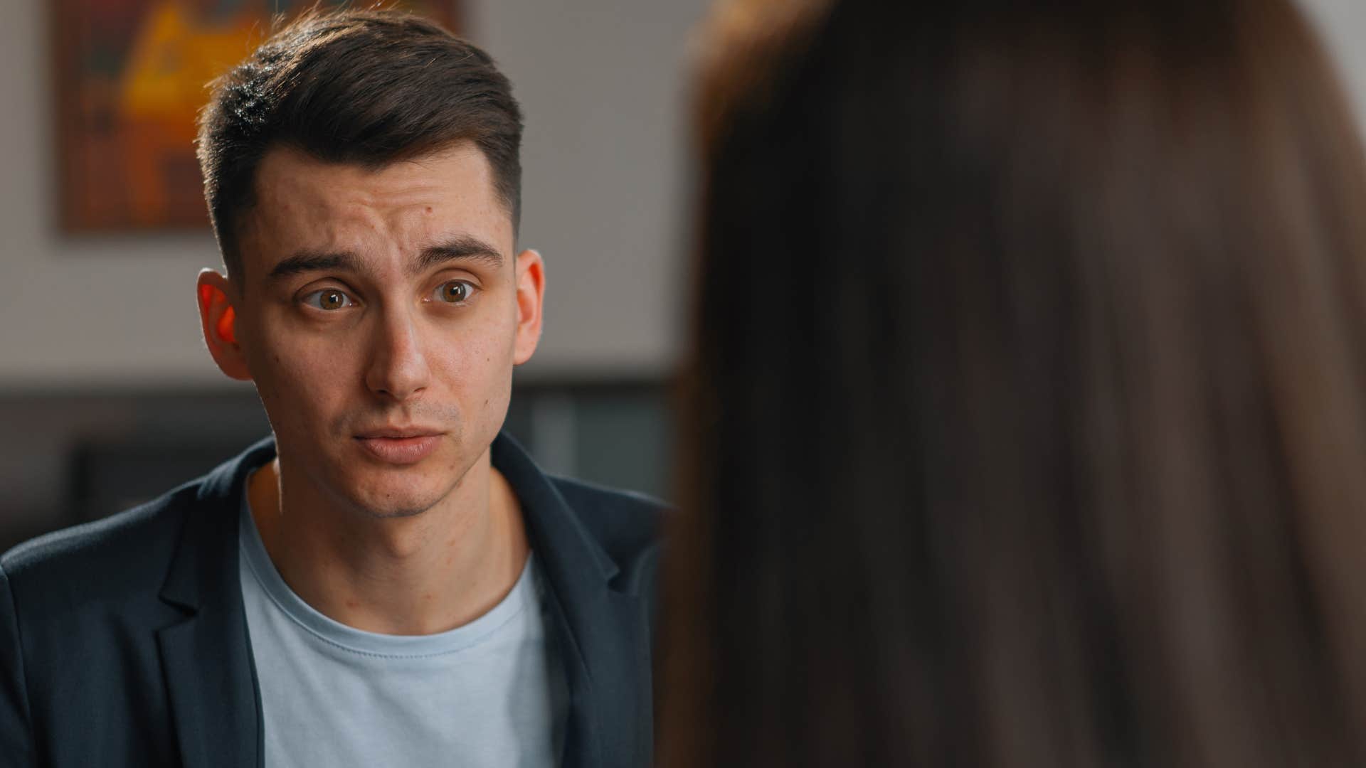 man listening to woman speak thinking she has no idea what shes talking about