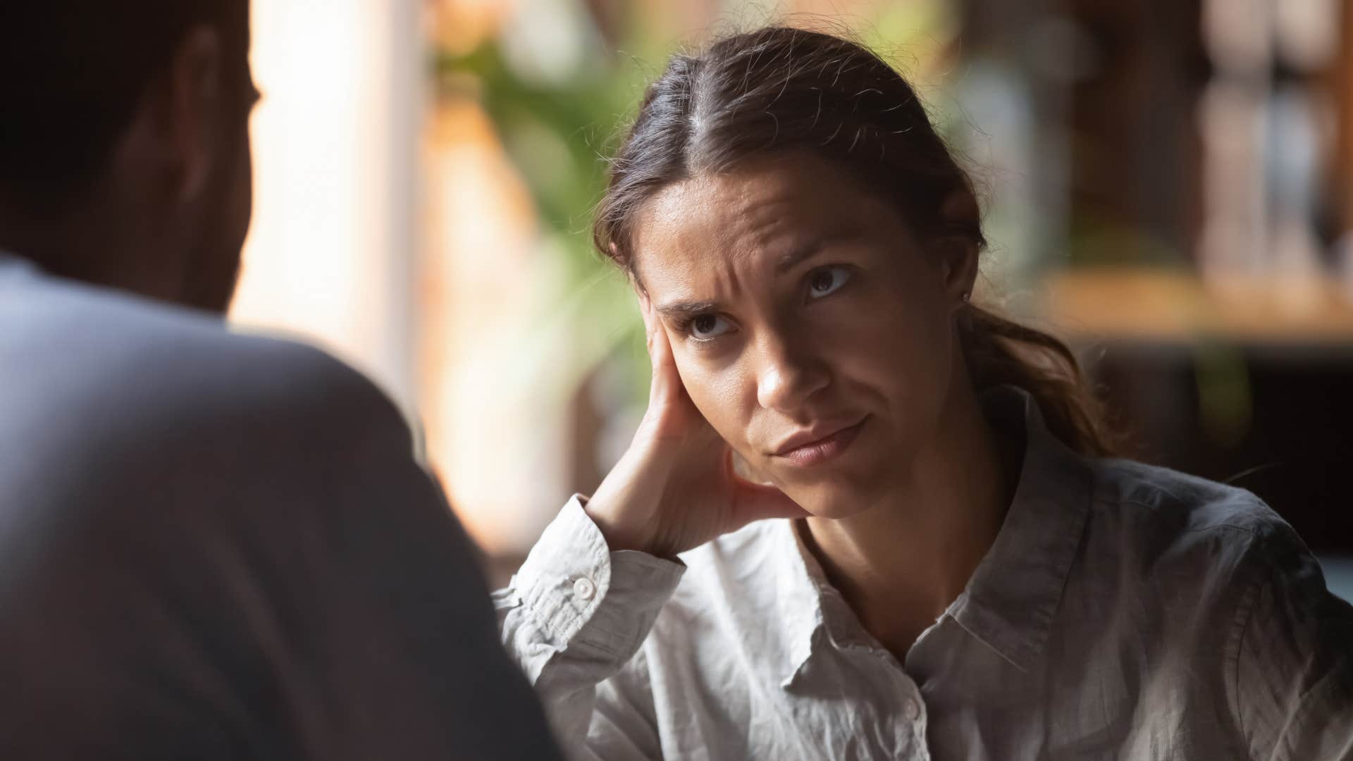 woman thinking you're not fooling anyone looking at man disgusted