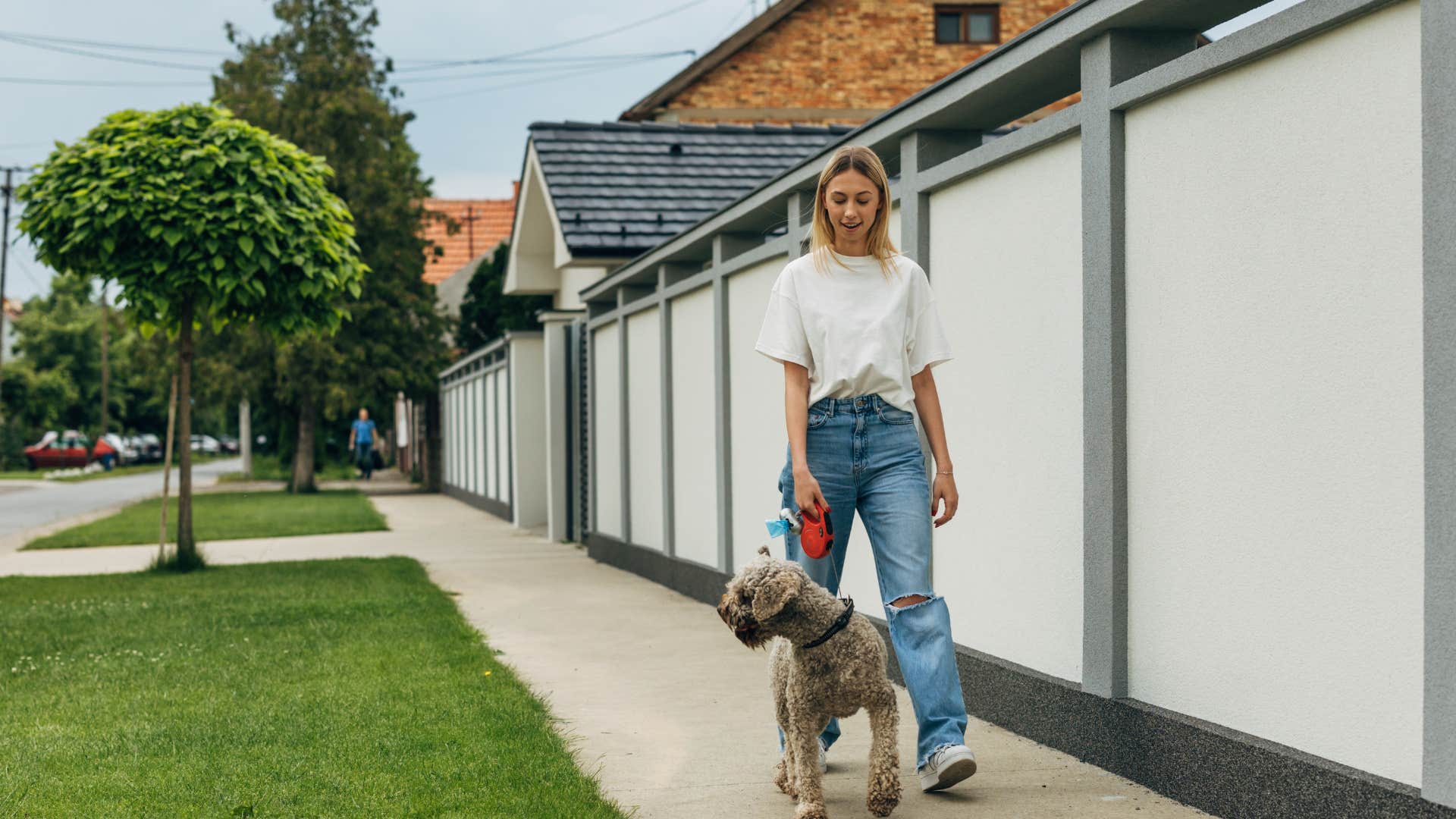 wealthy woman walking her dog in a safe neighborhood