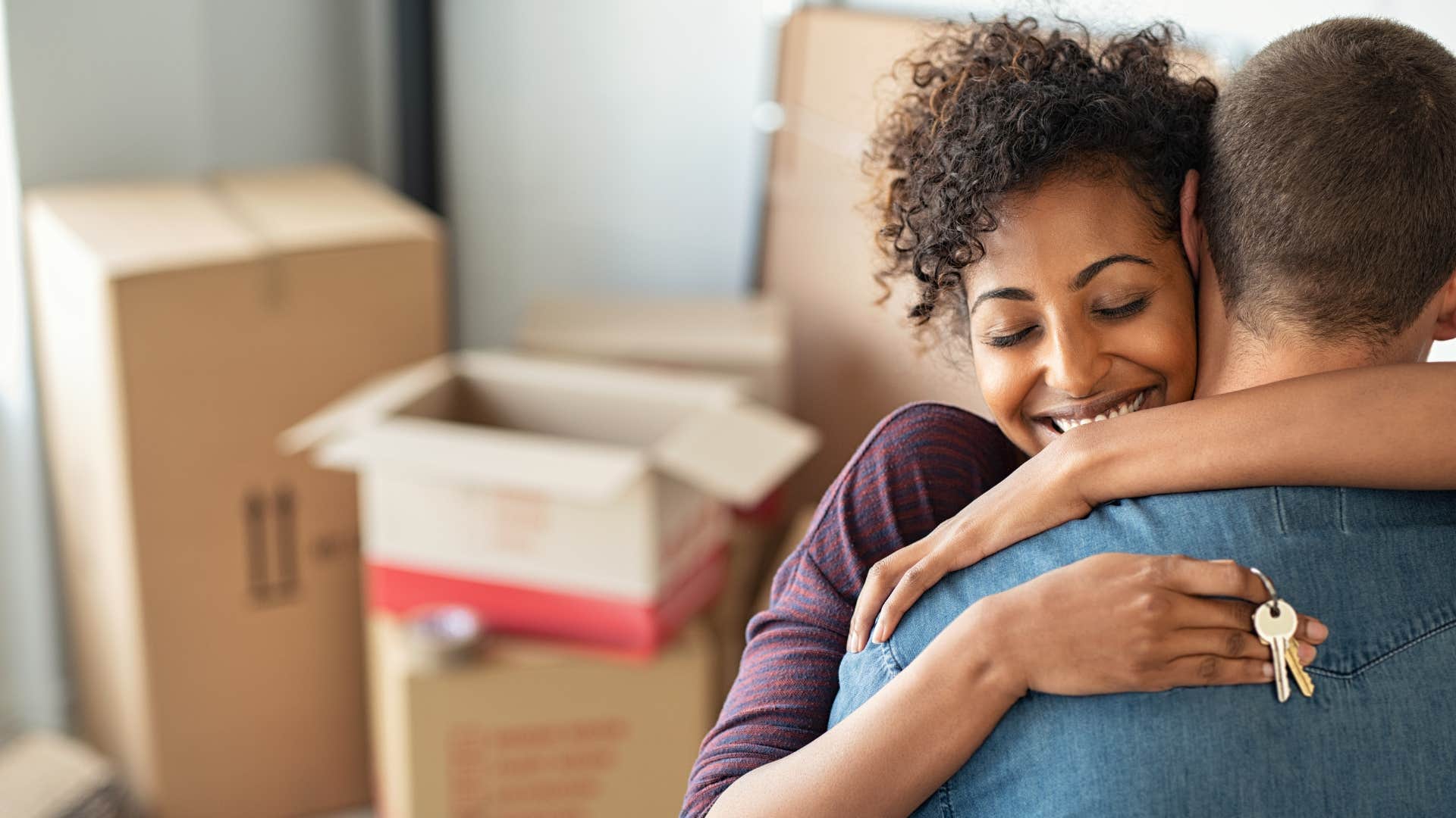 wealthy couple hugging in their new home