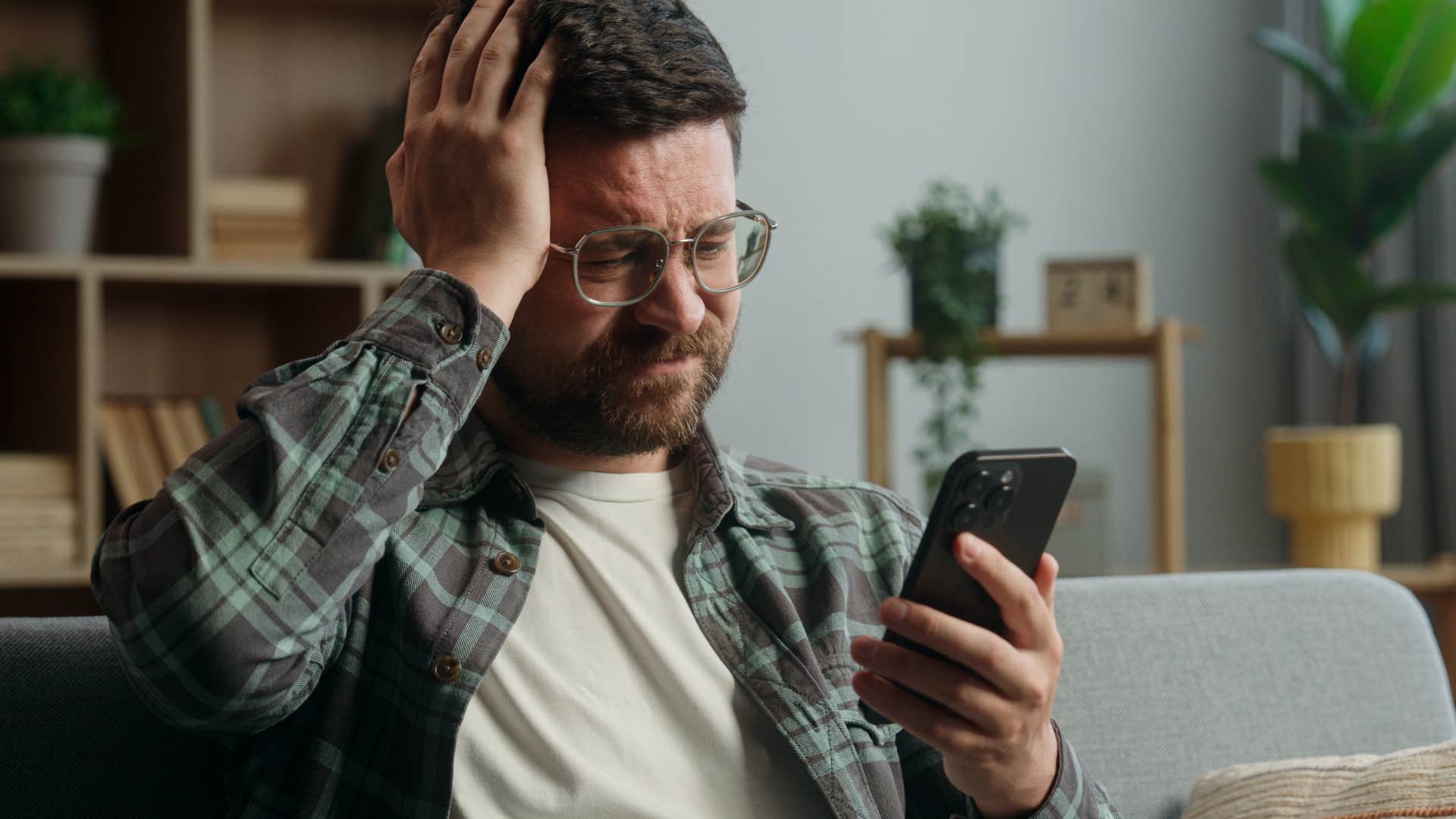 emotionally exhausted and stressed man thinking about digital communication on his phone