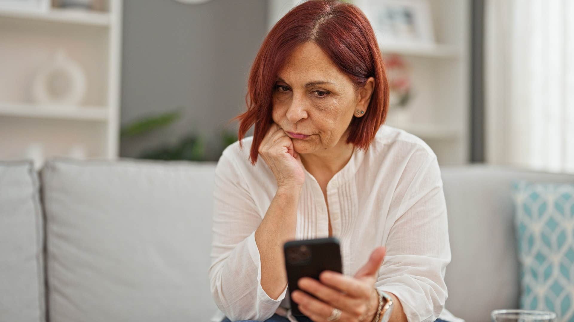 emotionally exhausted woman avoiding social events sitting at home